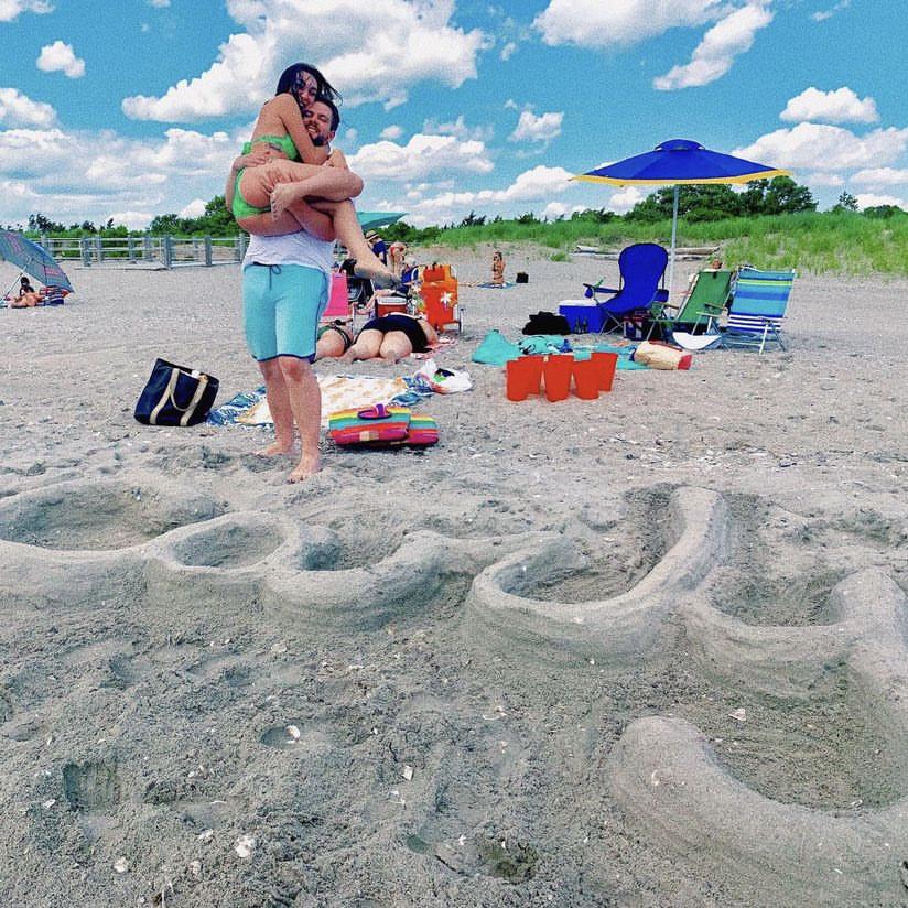 First beach trip together - 2019. Dylan wrote Carly’s name in the sand while she was napping!