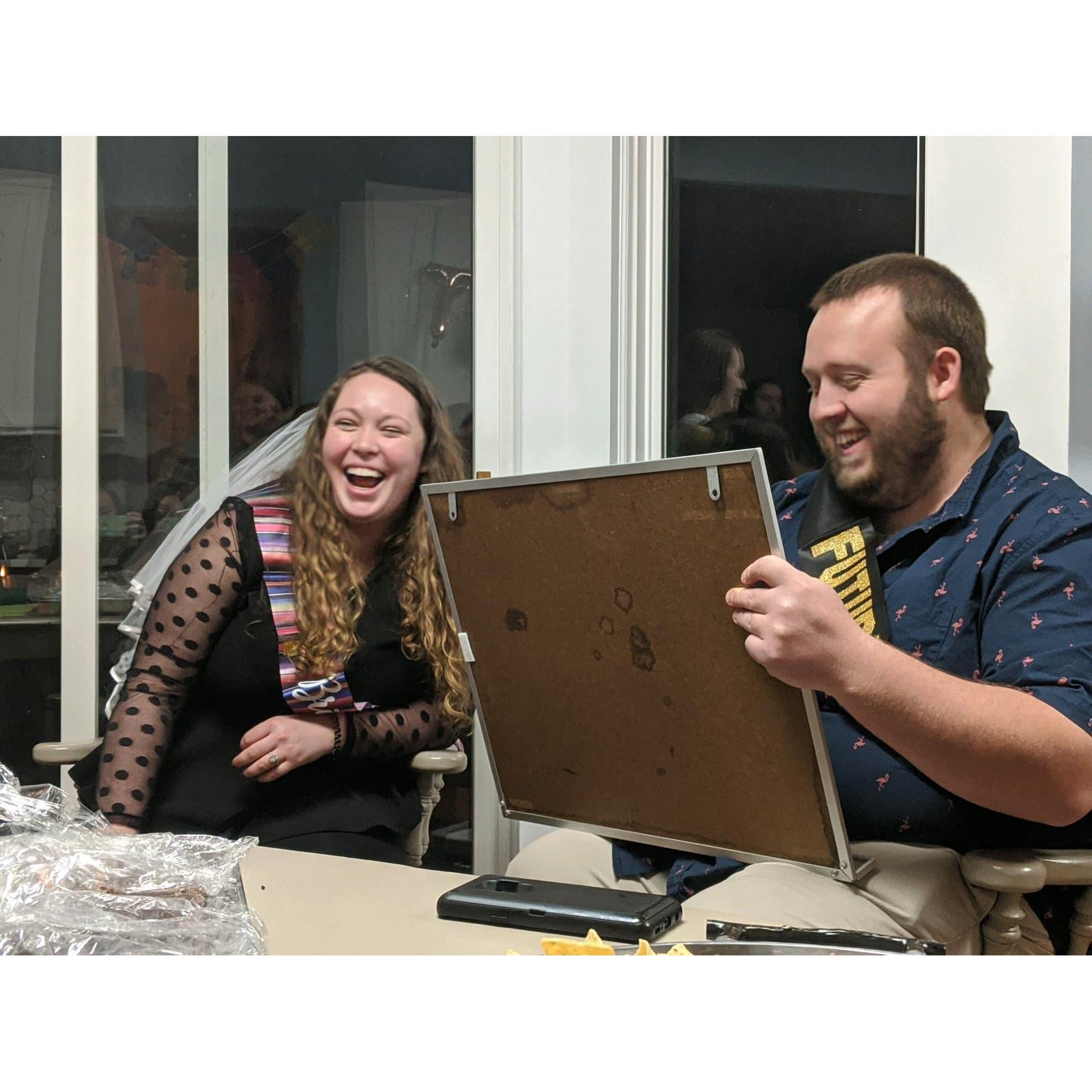 Katie and John keeping score during Couples Jeopardy at their Engagement Party!