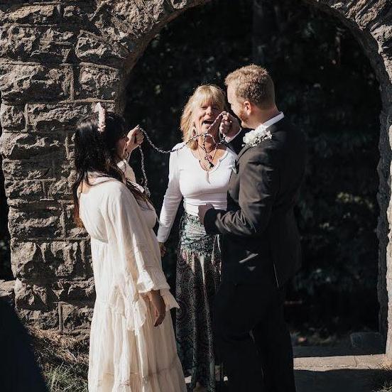 Nancy leading the handfasting prayer.
