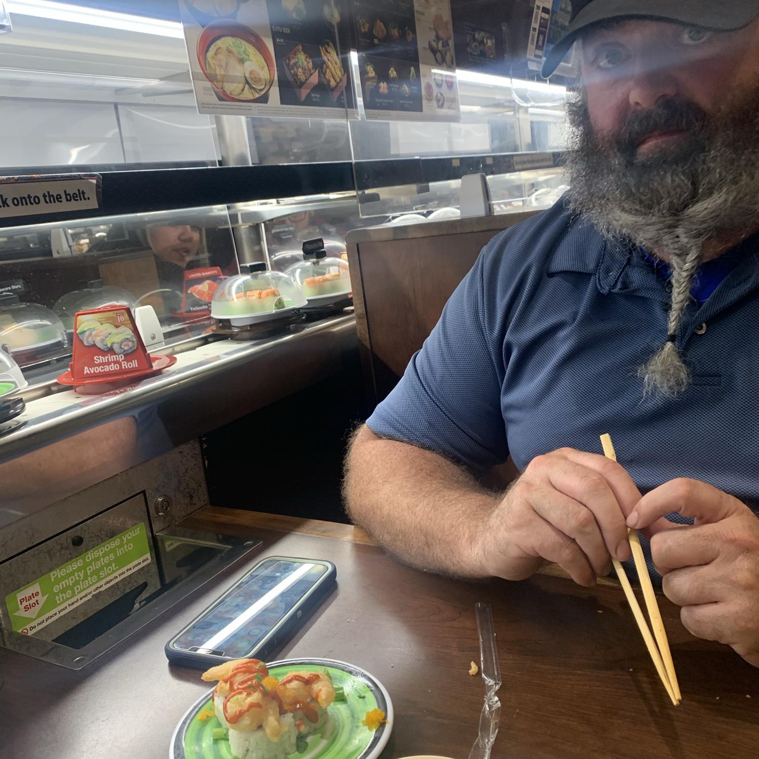 October 17, 2021 Our first time eating at a sushi bar on a conveyer belt where you get points for cleared plates put in the trash shoot. You watch a cute cartoon and can win cute little prizes.