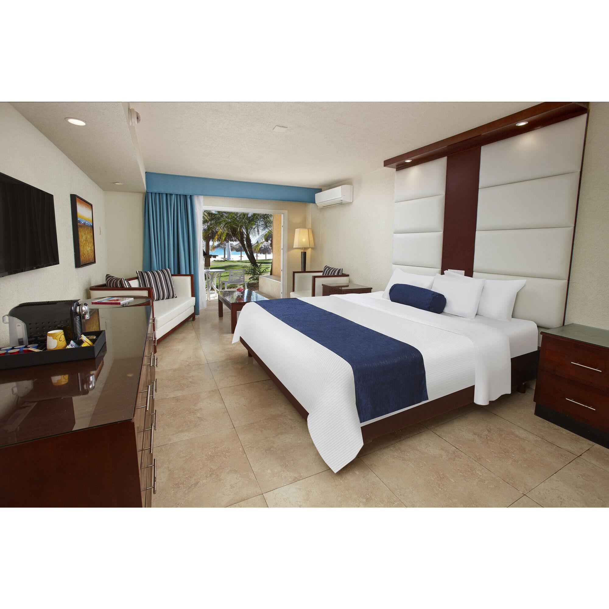 DIVI Ocean View: Enjoy views of the Caribbean Sea on your patio or balcony located in two-story buildings with stairs or three- and four-story buildings with elevators. One king bed or two queen beds.