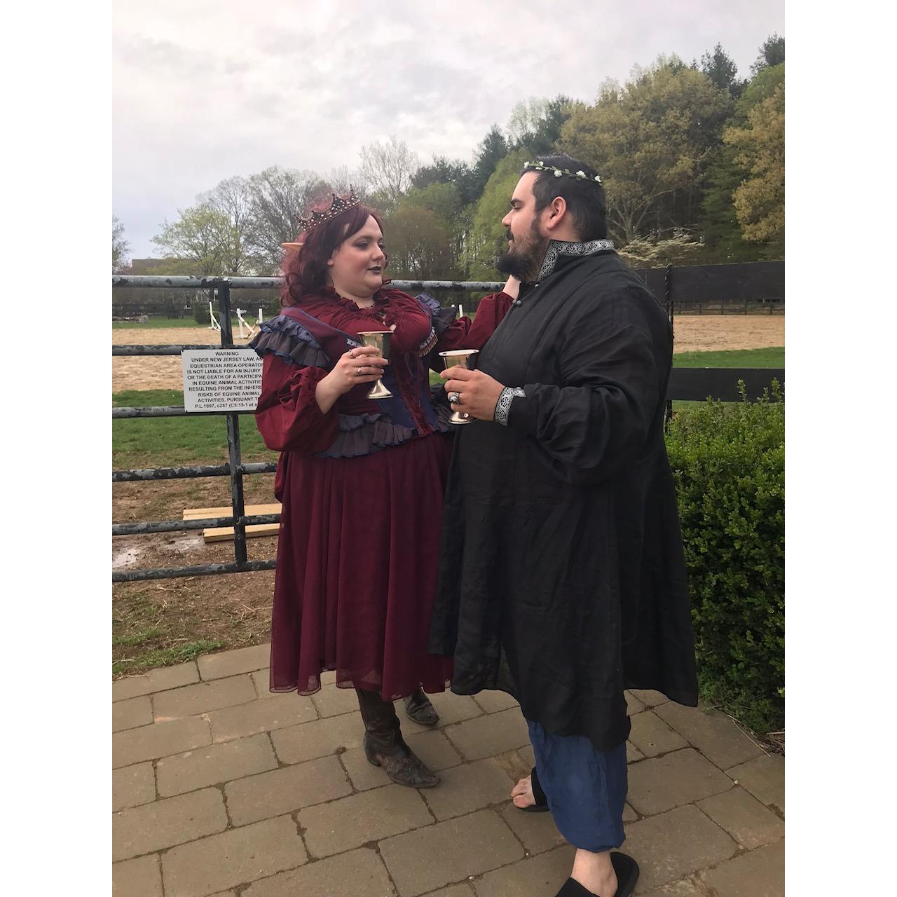 Julia and Gene attending a fantasy themed housewarming bonfire at their friend's tiny house on a ranch.
