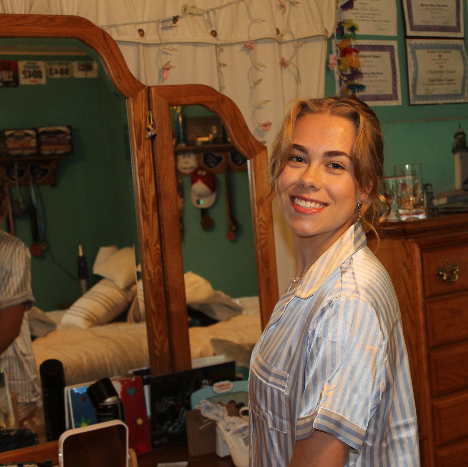 Leigh Anne getting ready in her childhood bedroom.