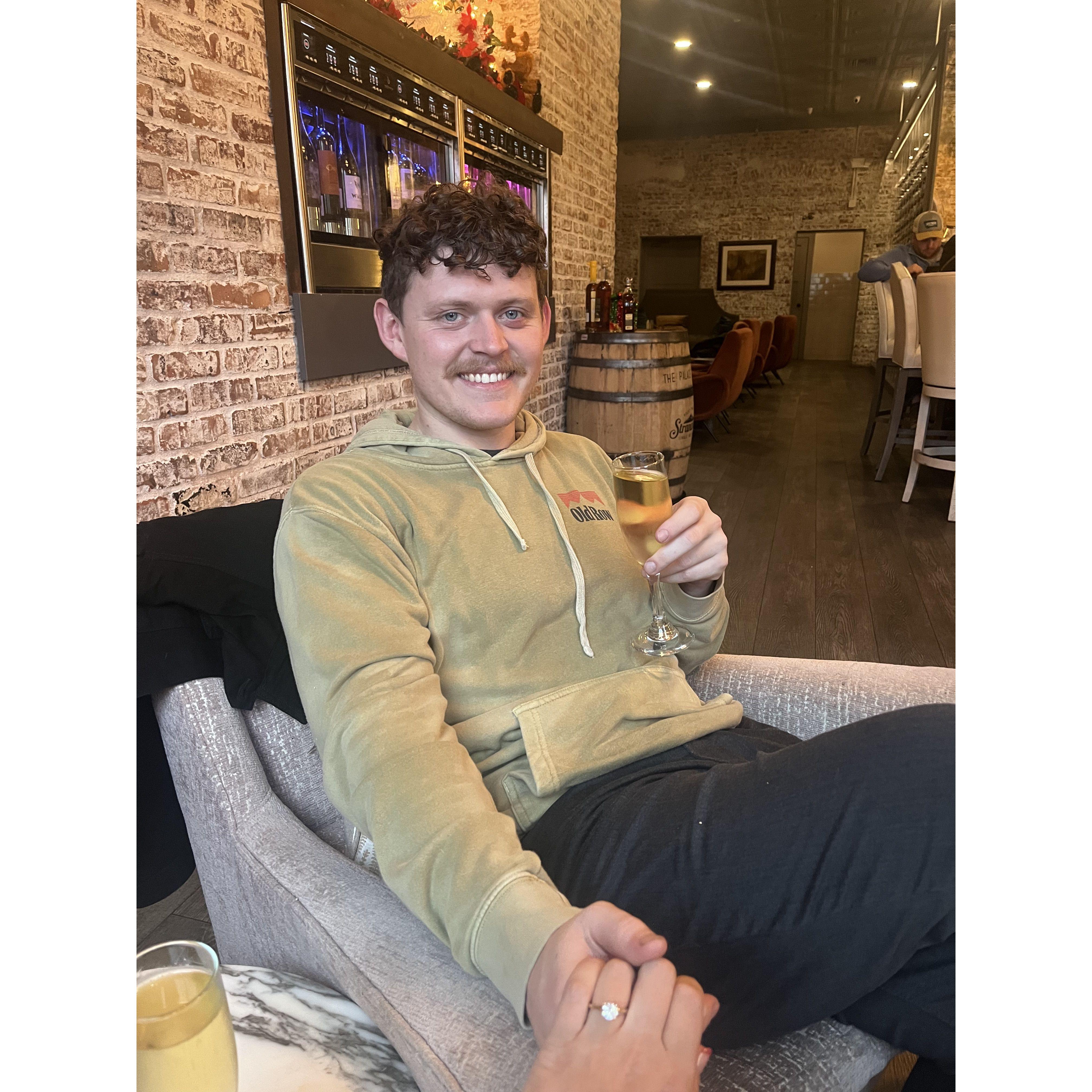 Celebrating with champagne after a rainy engagement on the Fernandina docks