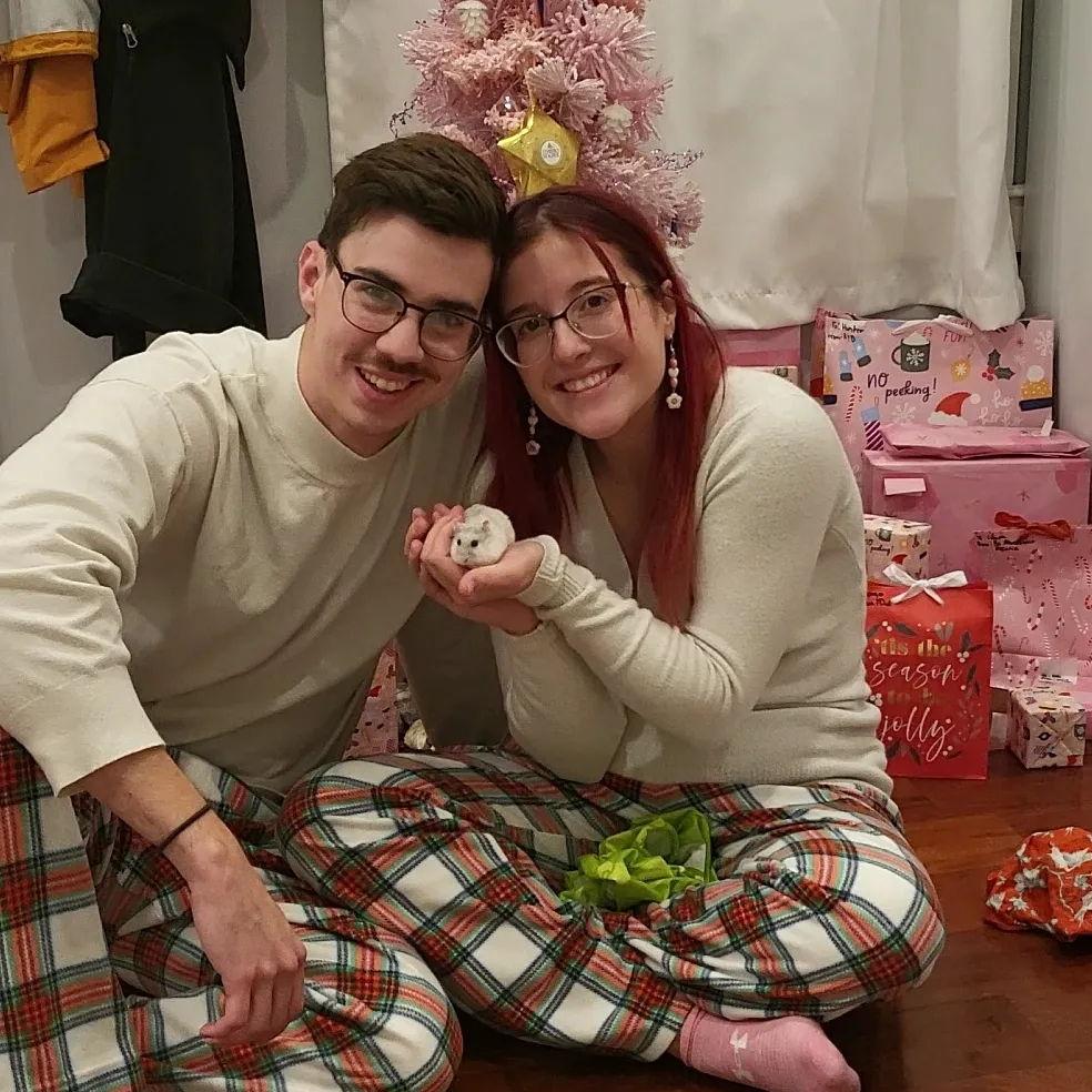 Our 2nd Christmas together in our first apartment together while holding Momo!