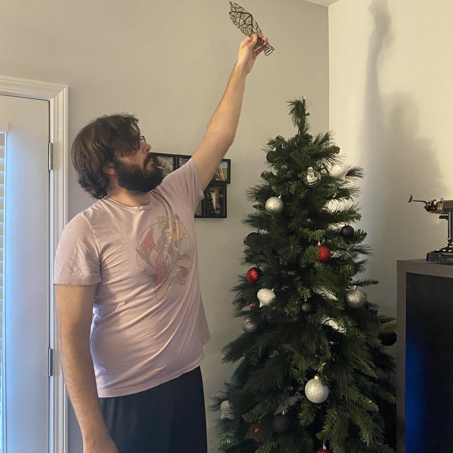 Dalton putting the finishing touches on their first Christmas tree, Burlington, North Carolina, November 2023
