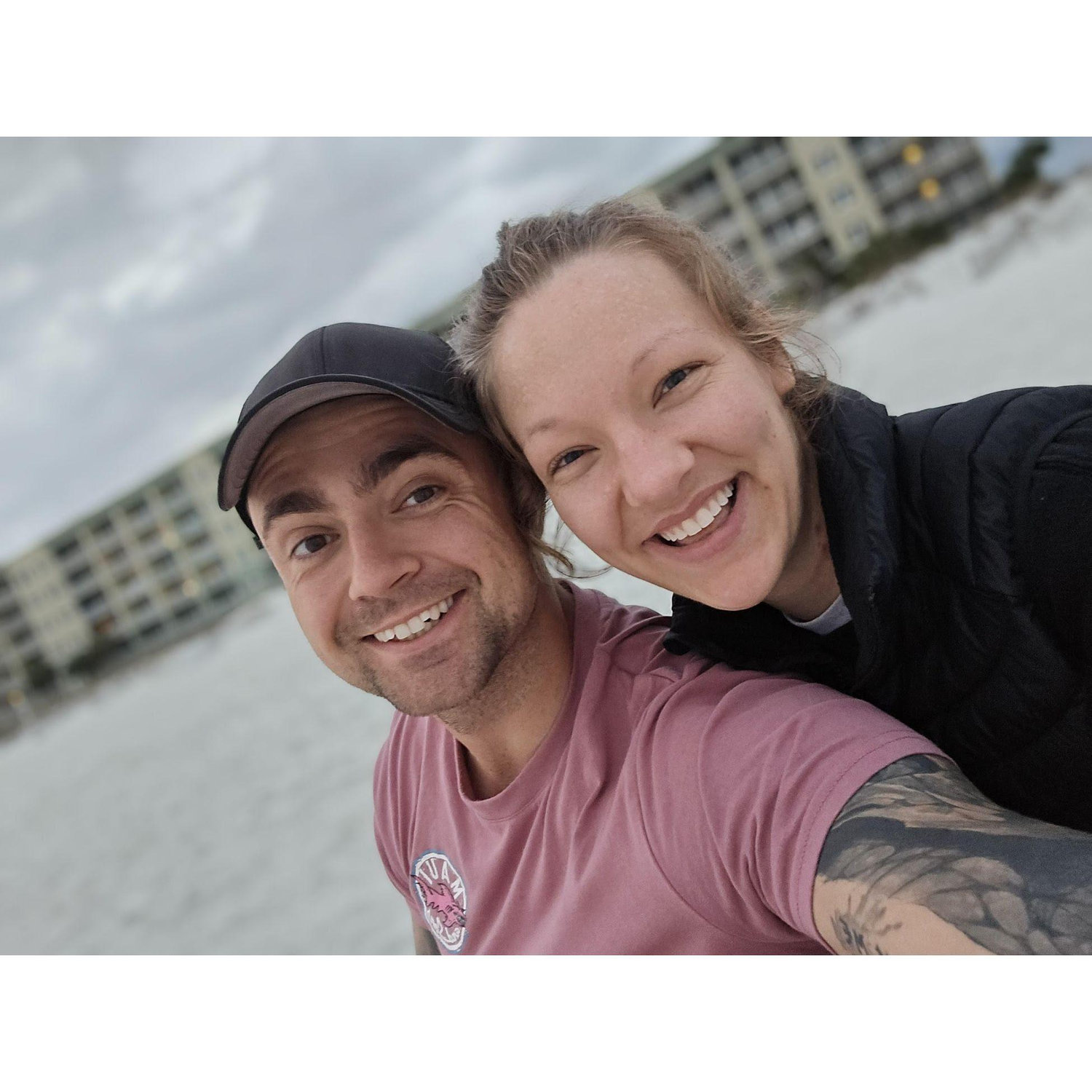 Maddie and Travis watching the sunrise on the beach in Destin, FL in March 2024