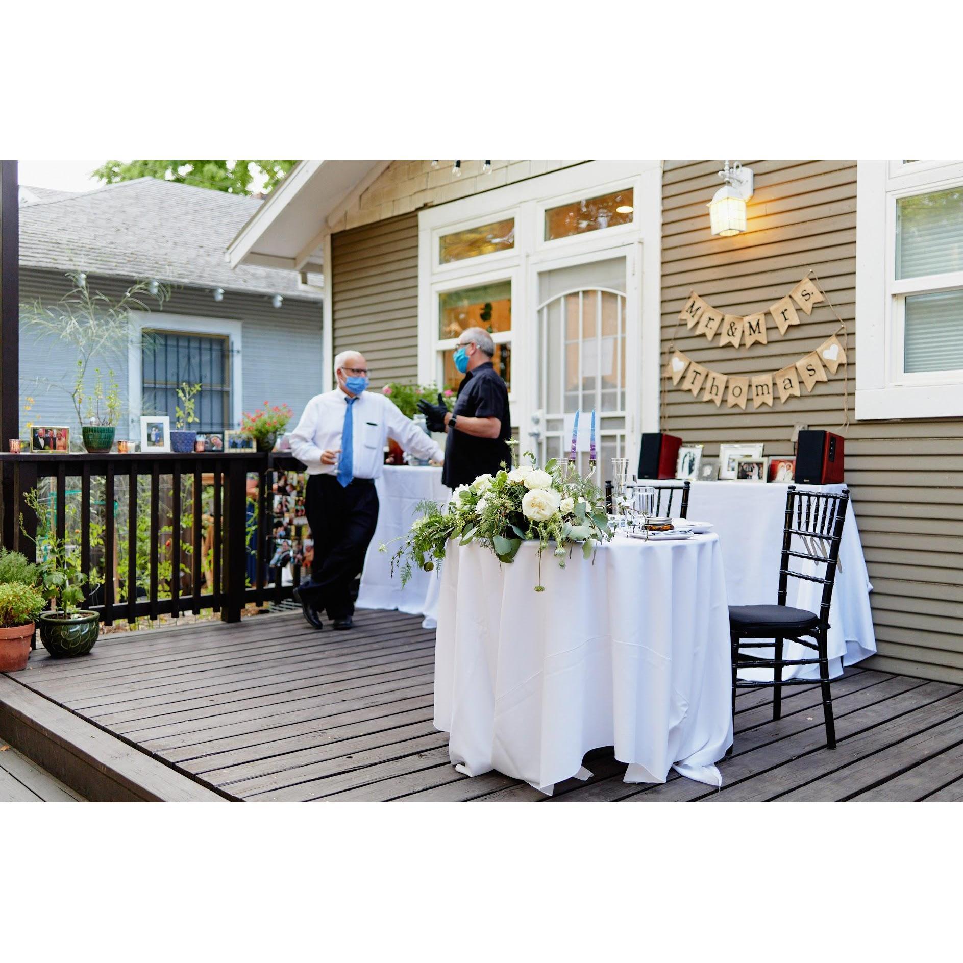 Rachel's father, Mike, and caterer on the decorated back porch of Rachel & Steve's backyard