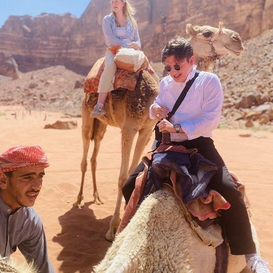 Riding camels in Jordan