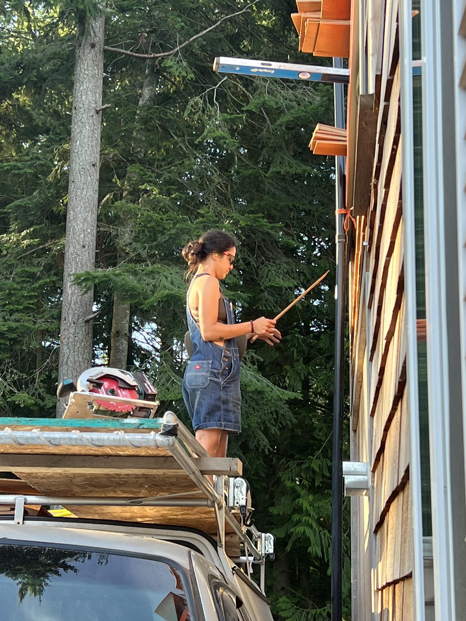 Putting shingles on our tiny house