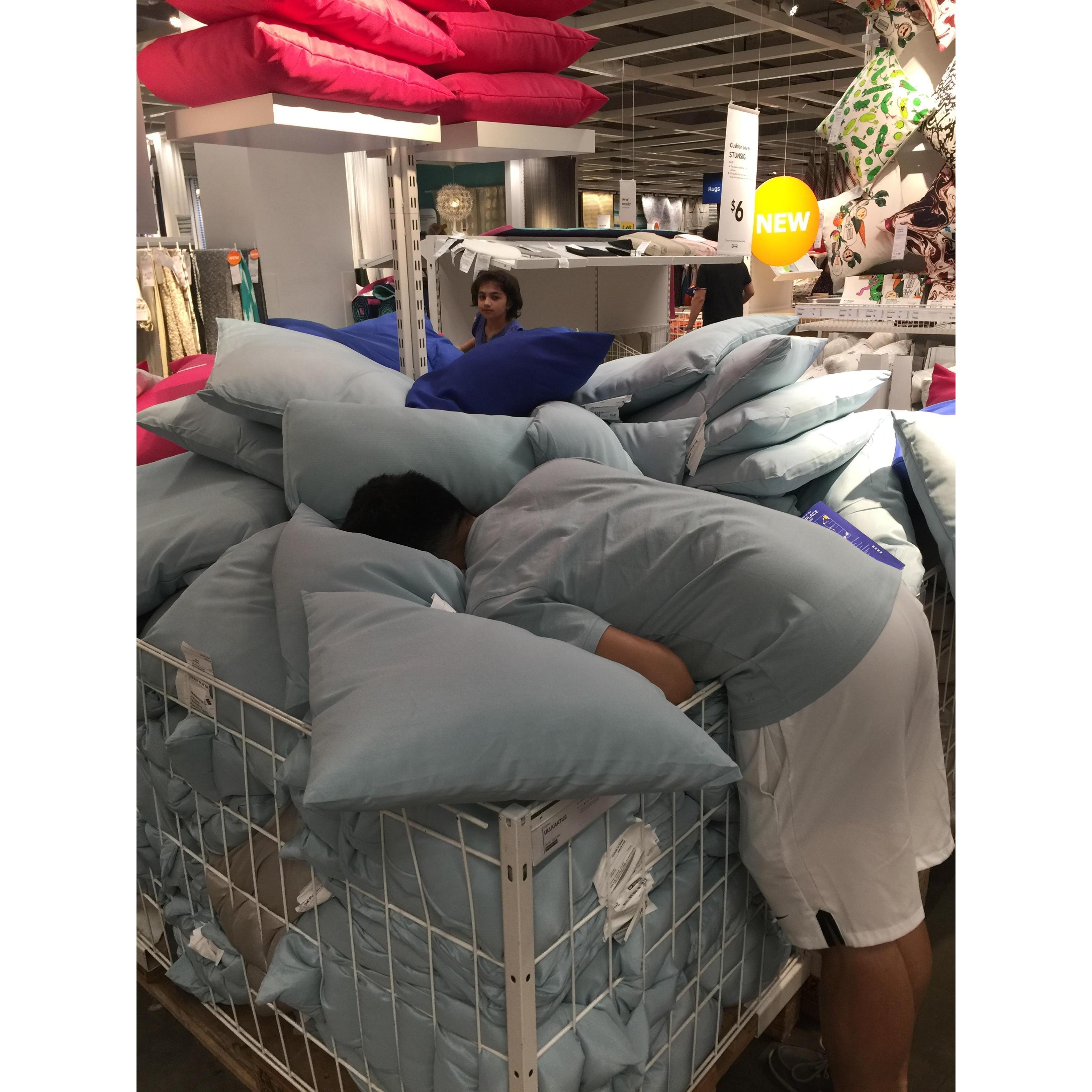 Jason wearing the same color as the pillows at Ikea and trying to blend in.