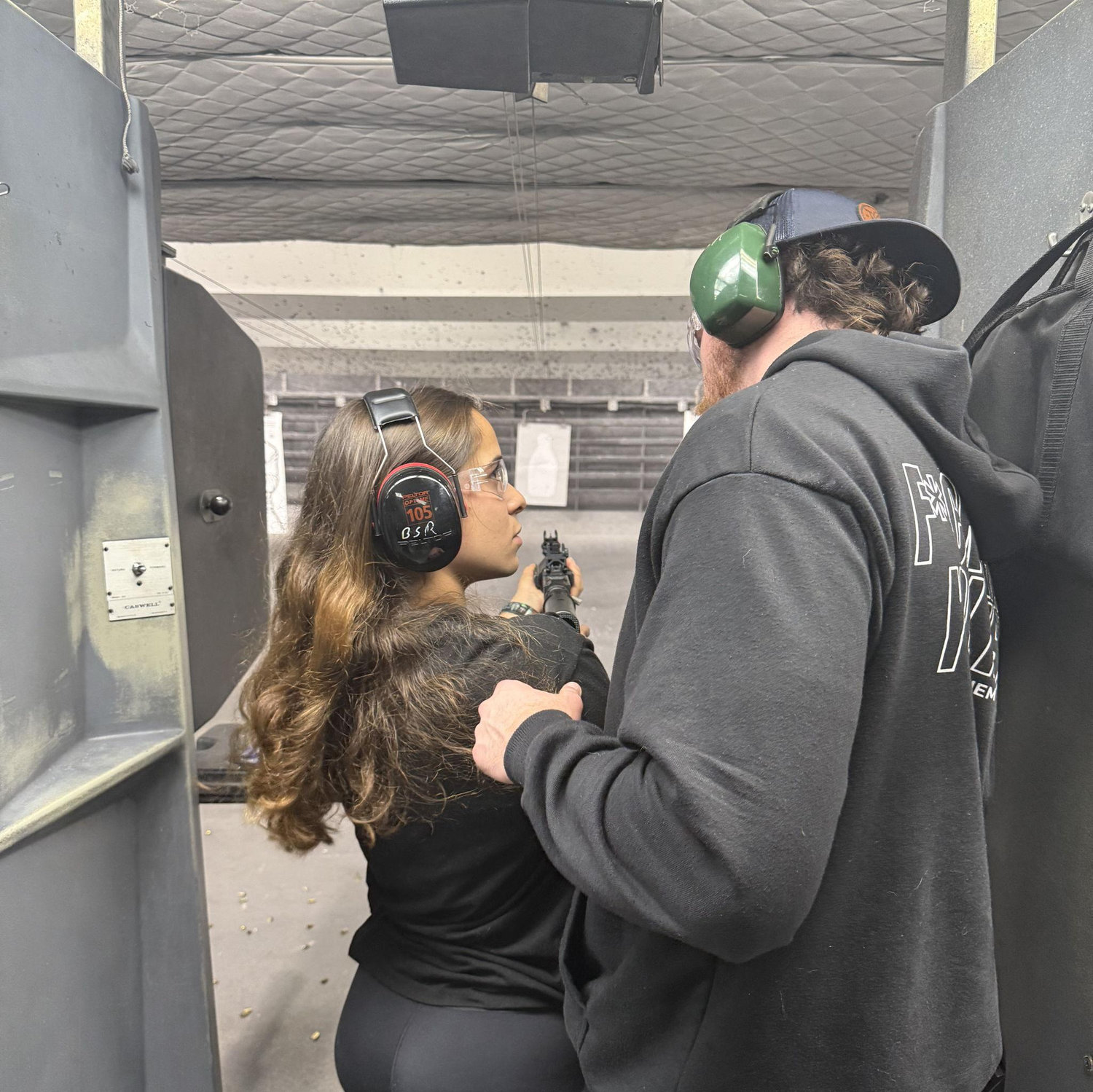 Bela never thought about touching a gun, here she was, first time shooting with Justin