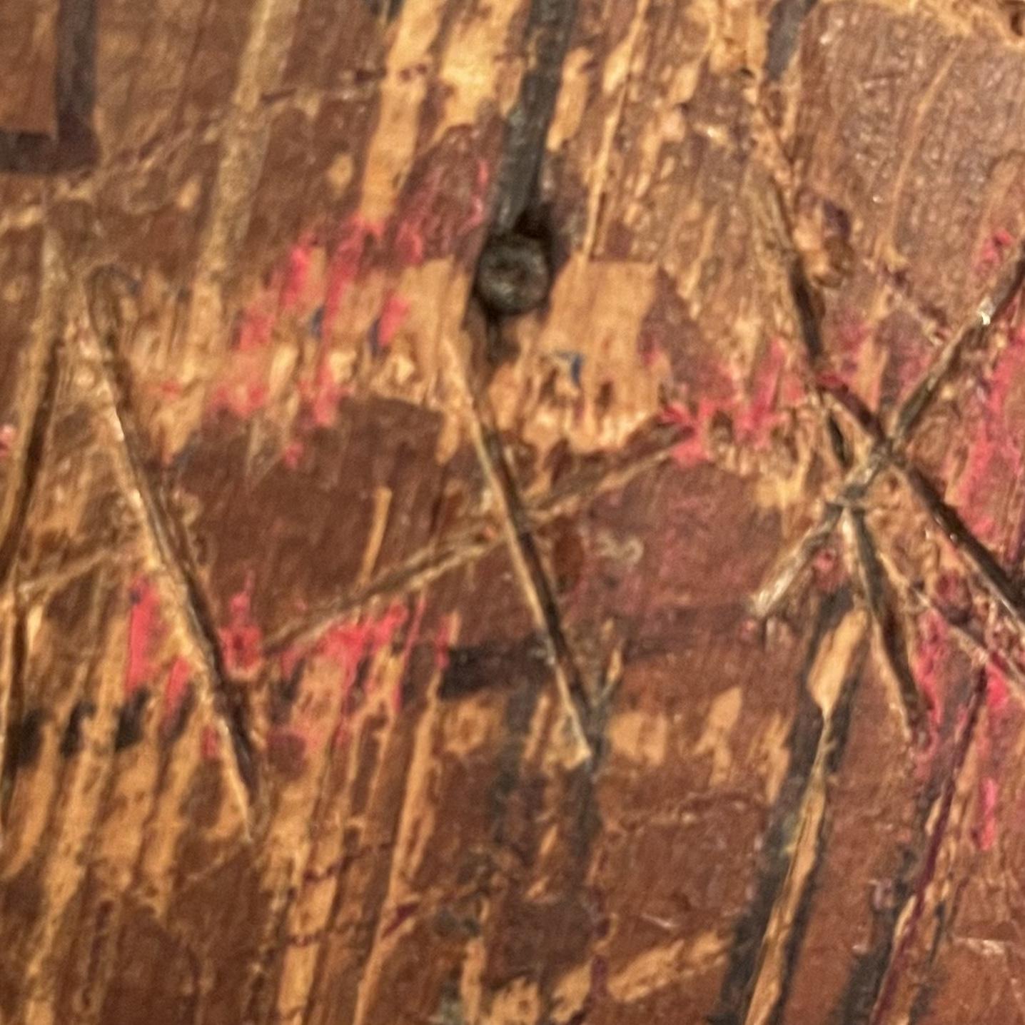 Kenny scratched out initials into a wall.