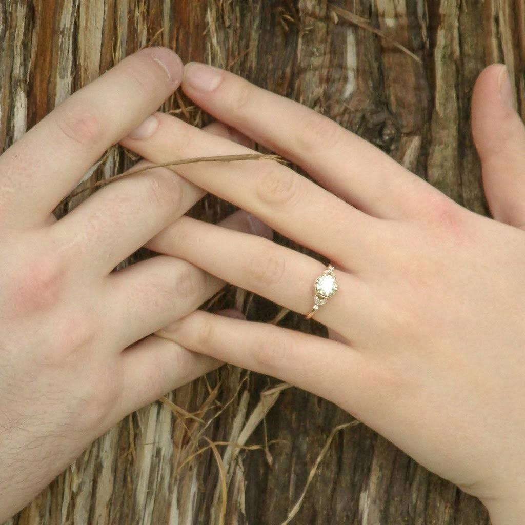 First time trying on the ring! Took forever to find but when we saw it, we knew. Carries a dazzling design just like her!