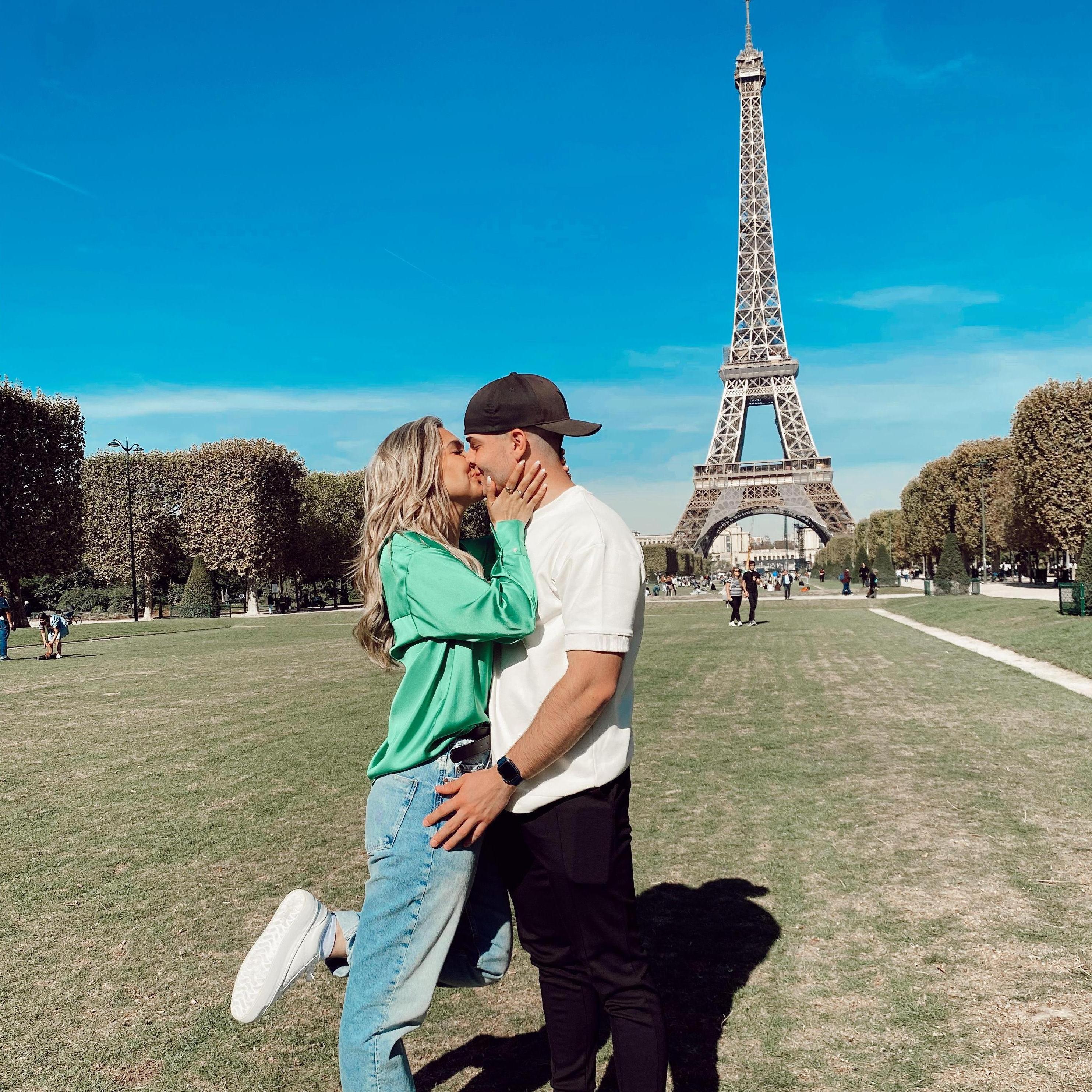 Kiss in front of the Eiffel Tower.