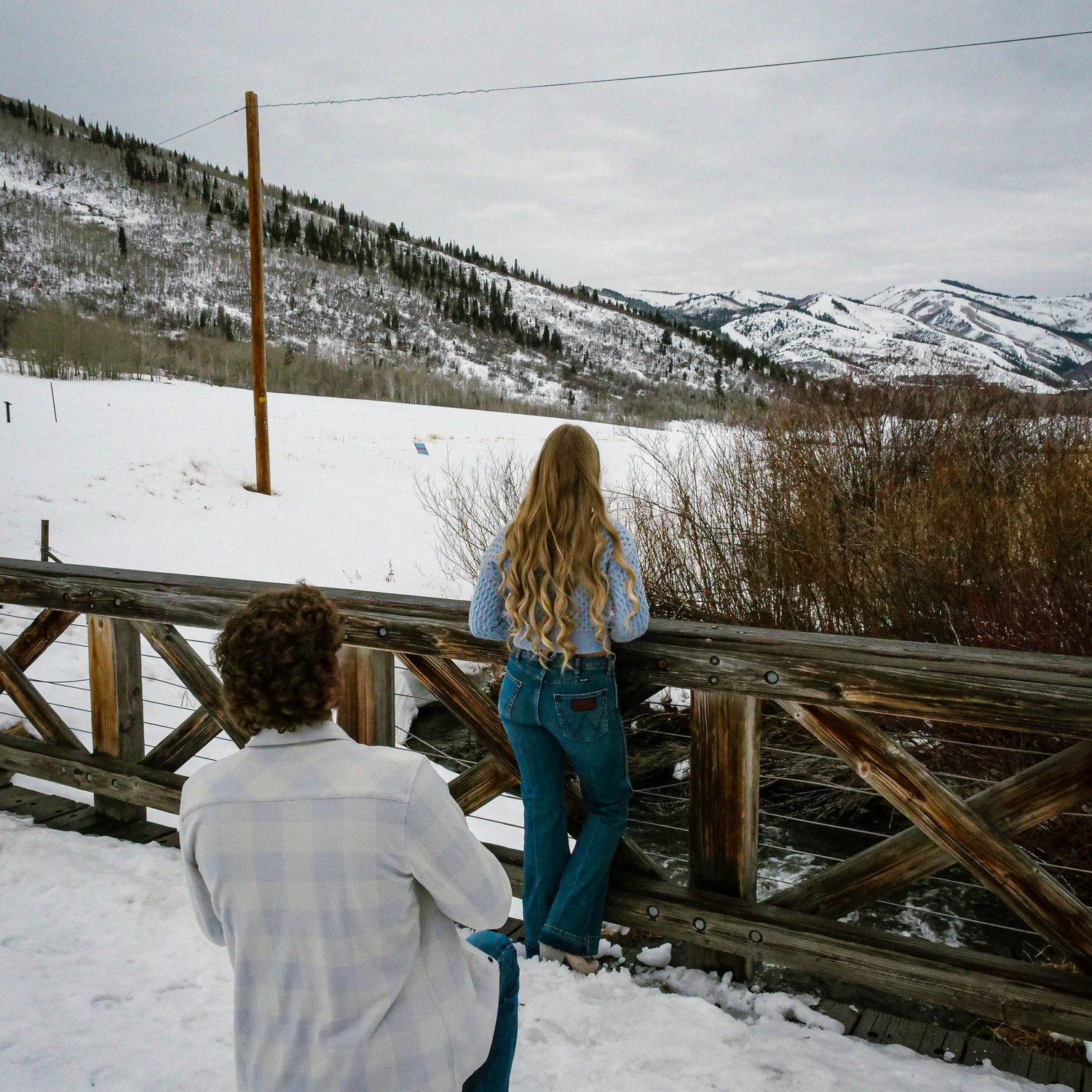 "Looking at the view" for a picture. Totally oblivious to him kneeling.