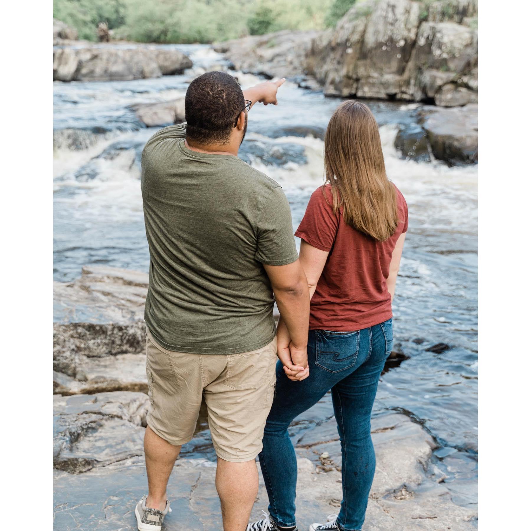 Logan is pointing to the rock at the top of the waterfall where they spent their first date together in 2015!