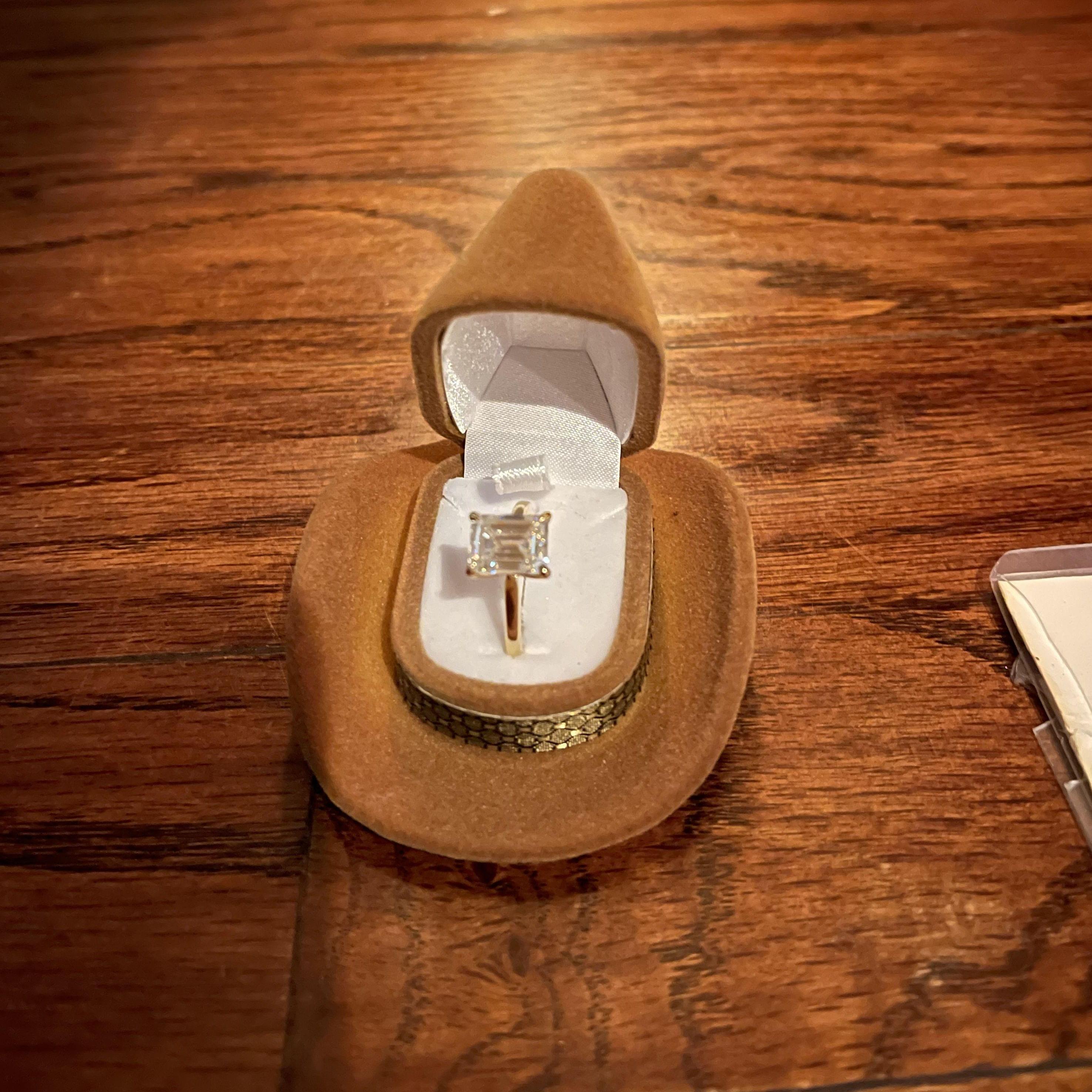 Mitch proposed with a ring box shaped like a cowboy hat. "We-Haw" :')