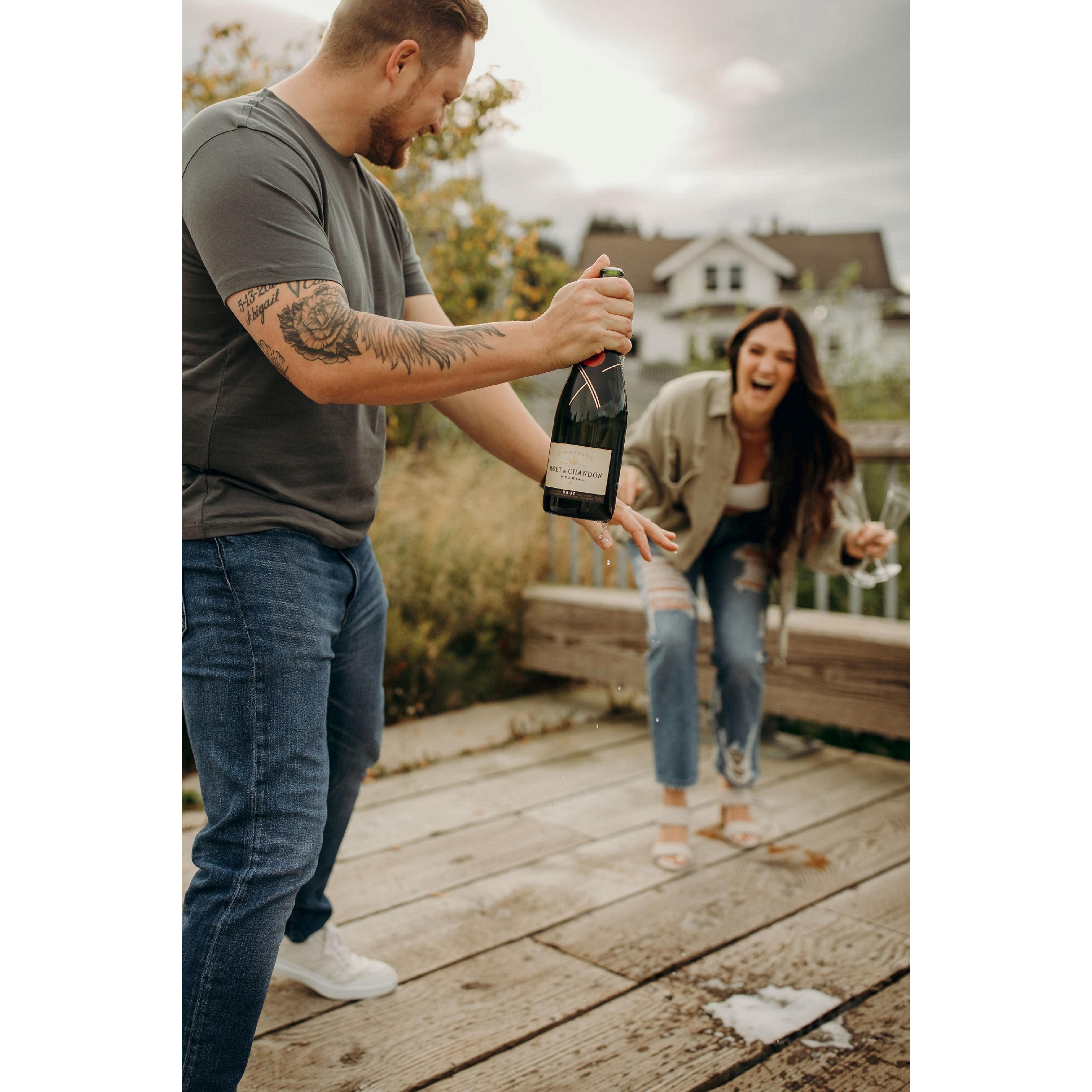 Popping champagne at the engagement shoot!