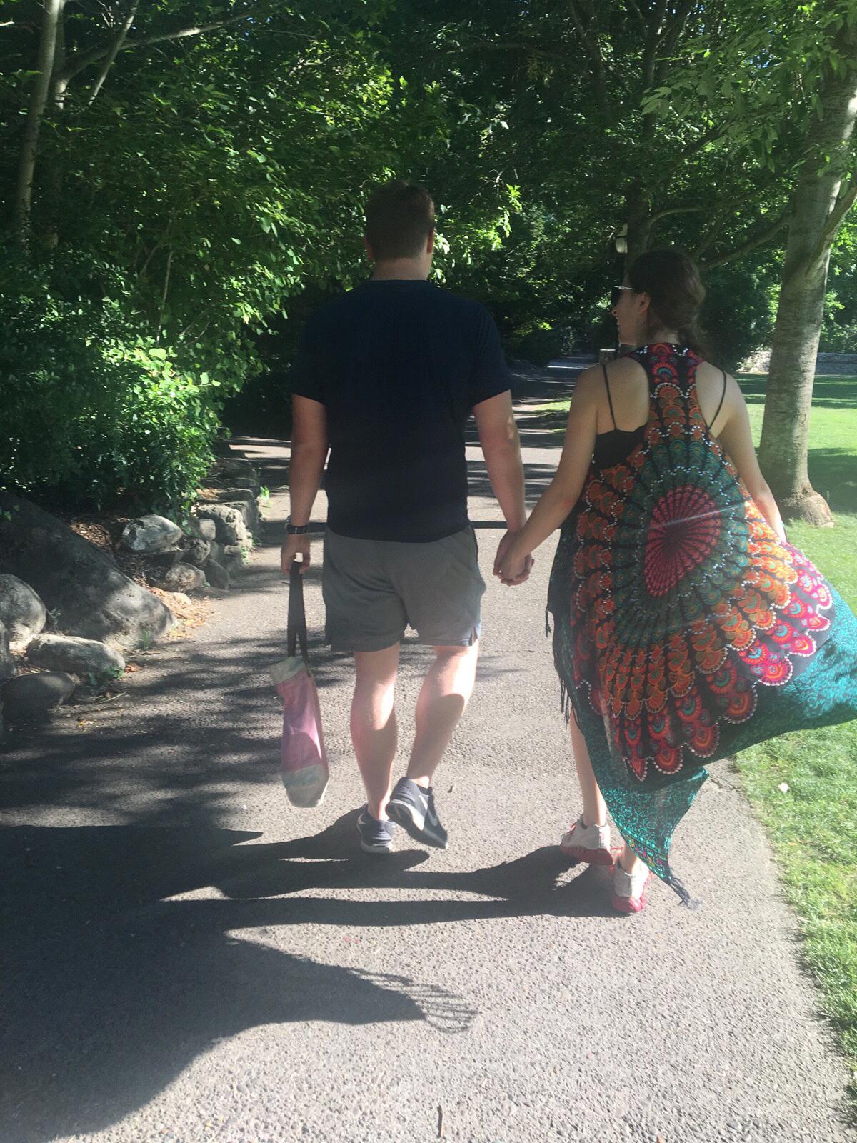 Walking hand in hand in a park in Ashland