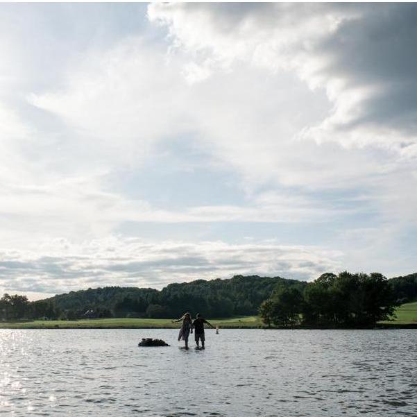 The happy couple enjoying one of their favorite activities together - casually standing in the middle of the lake.