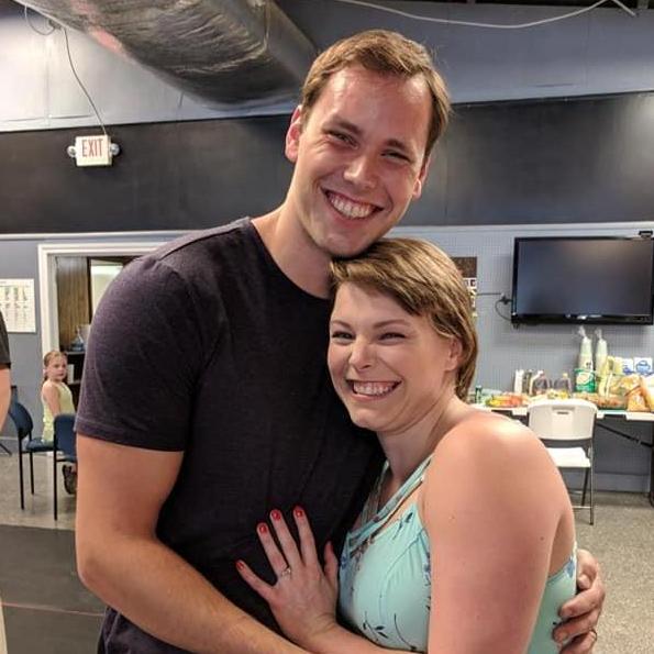 At the Engagement Party, surrounded by friends and family.