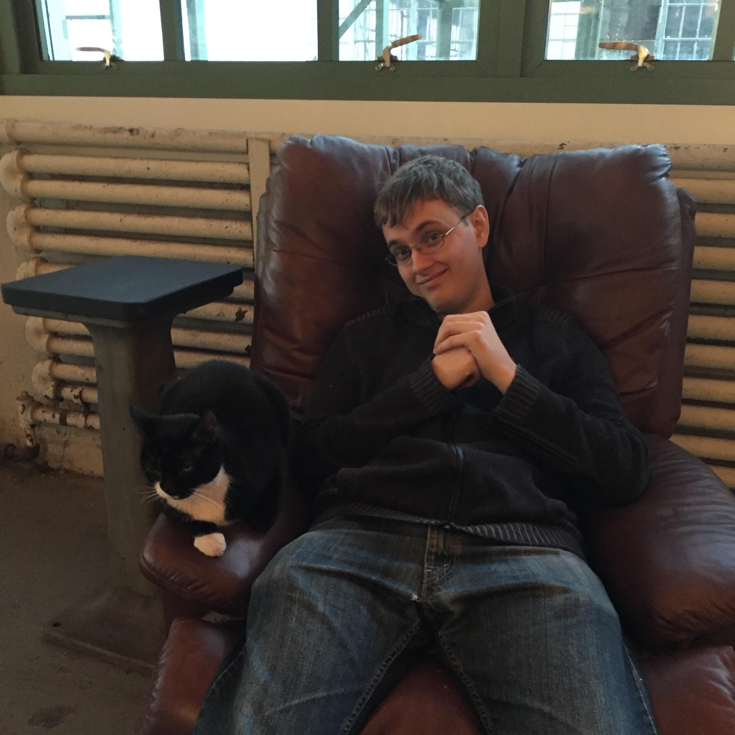 Ben bonding with Industry City Distillery's cat, Scratchy.