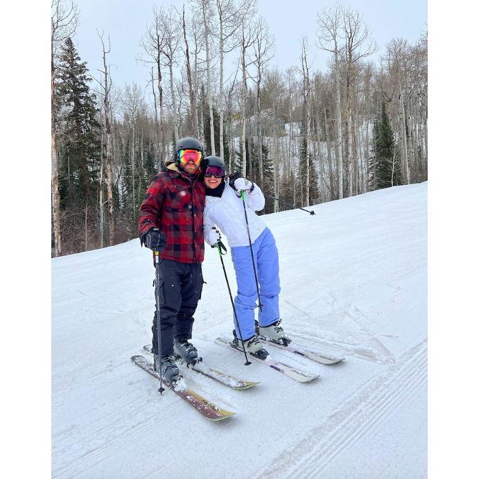 Michael teaching Raquel to ski