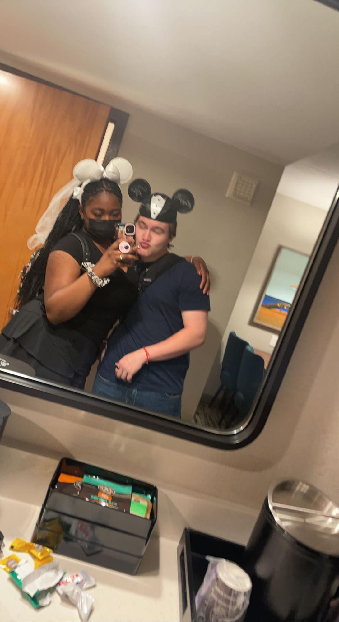 Here's us in the hotel after a little break from our day at Disneyland! We loved our bride and groom ears!