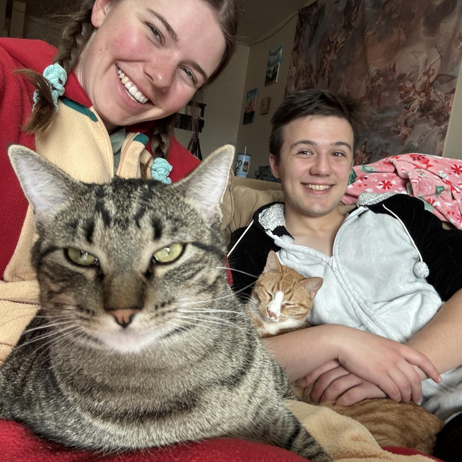 Lounging with our cats, Salix and Raphe, in our old apartment.