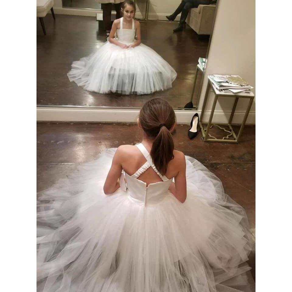 Emmie, our flower girl, having fun trying on different dresses