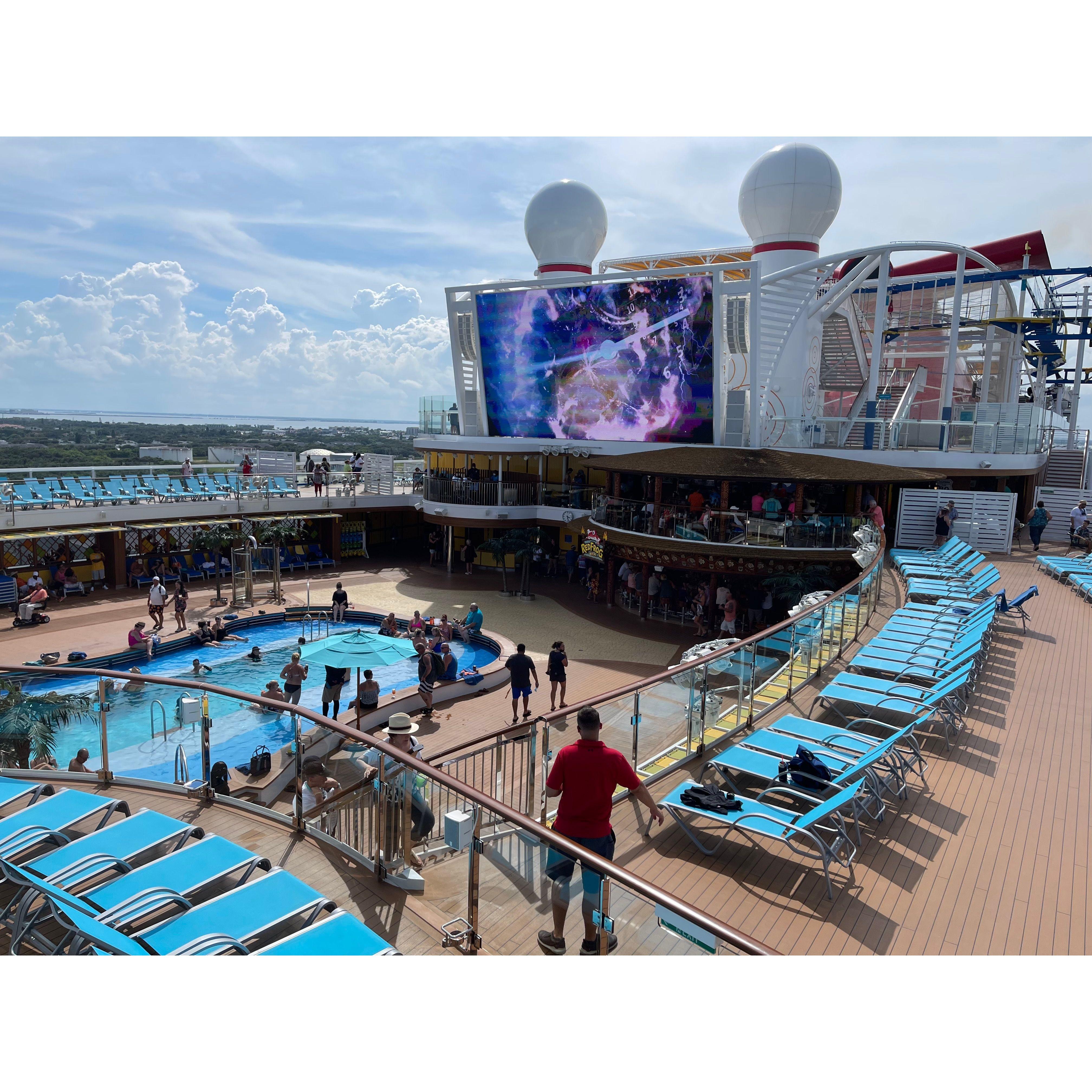 Lido Deck onboard. Recently released movies are played onboard for all to enjoy on the giant screen throughout the sailing!