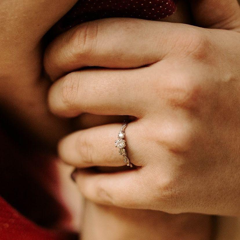 Close up of the ring! The center stone was his great-grandma Daisy's, and the two side stones were a pair of his mom's earrings <3
