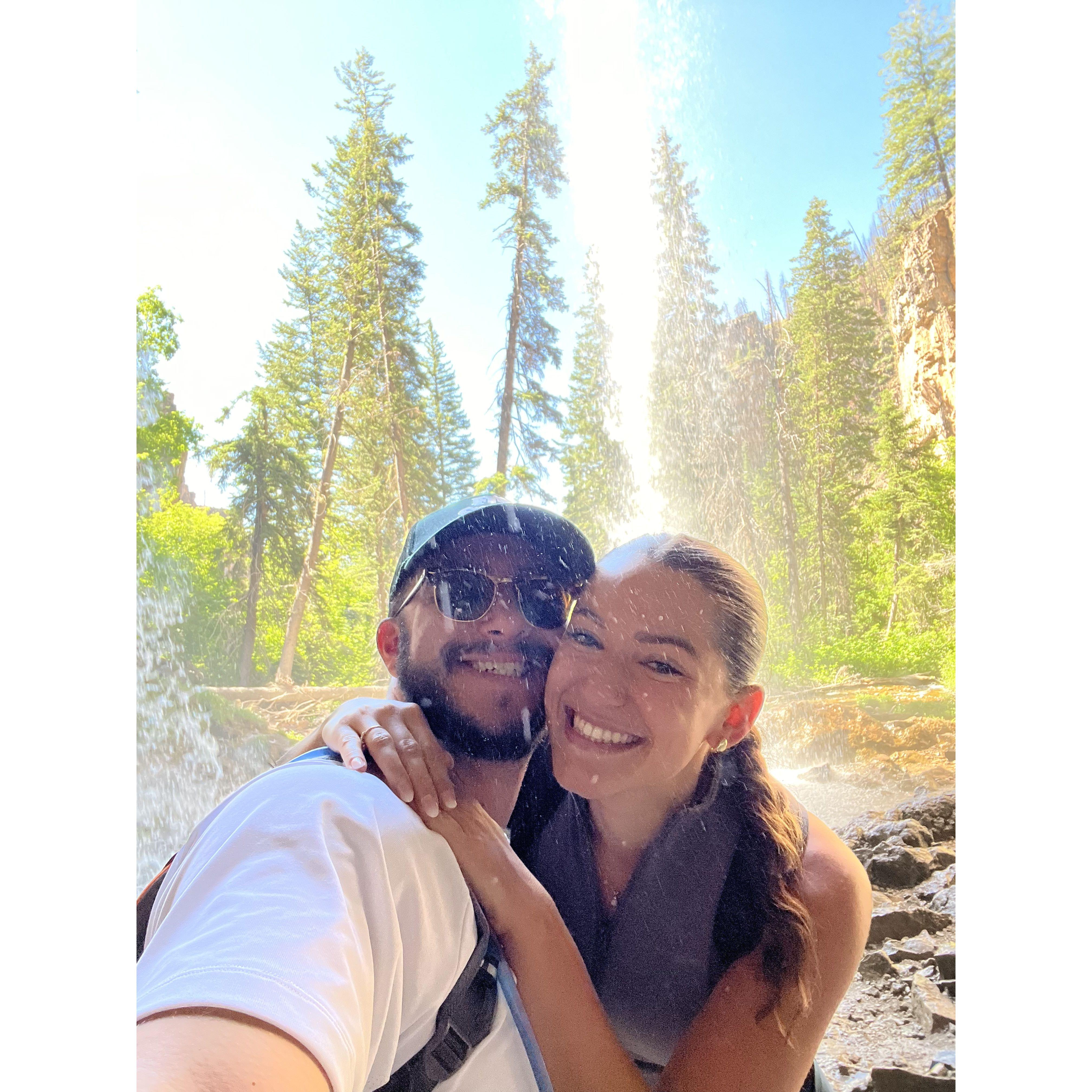Under a waterfall after our hike up Hanging Lake trail in Glenwood Springs, CO