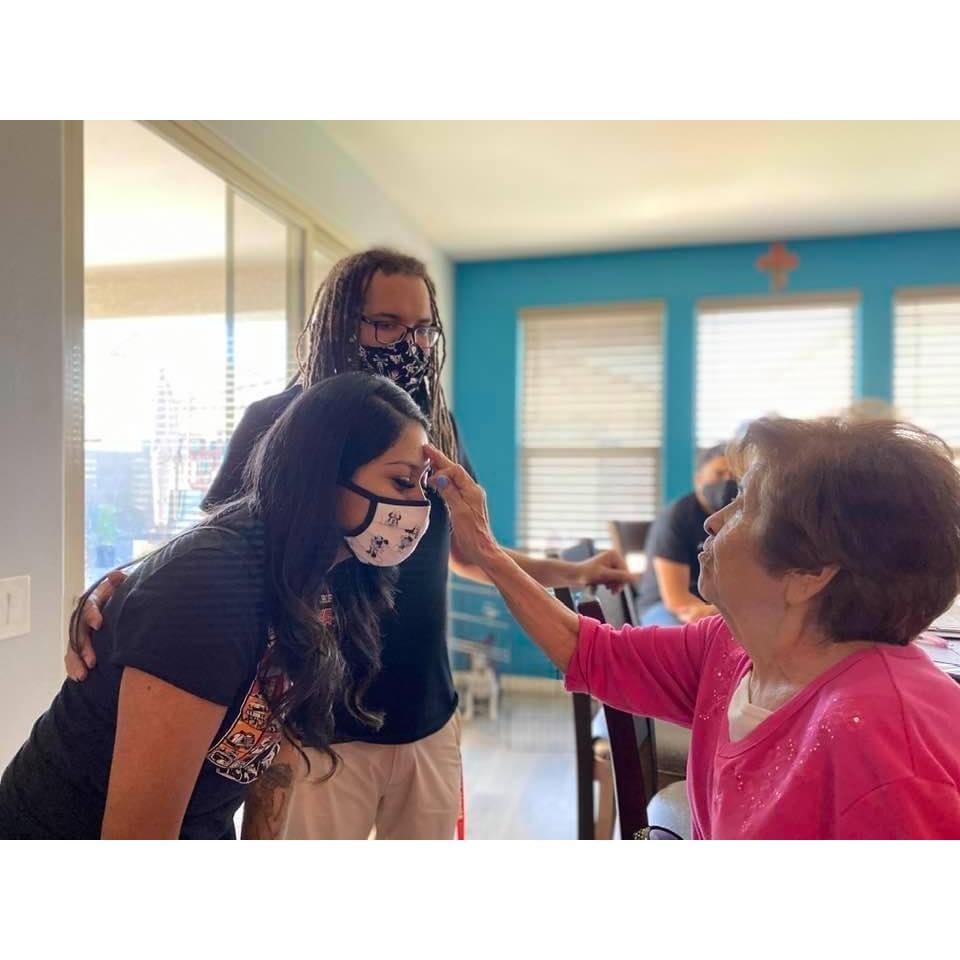 Grandma Dolores giving Alyssa a blessing during wedding prep