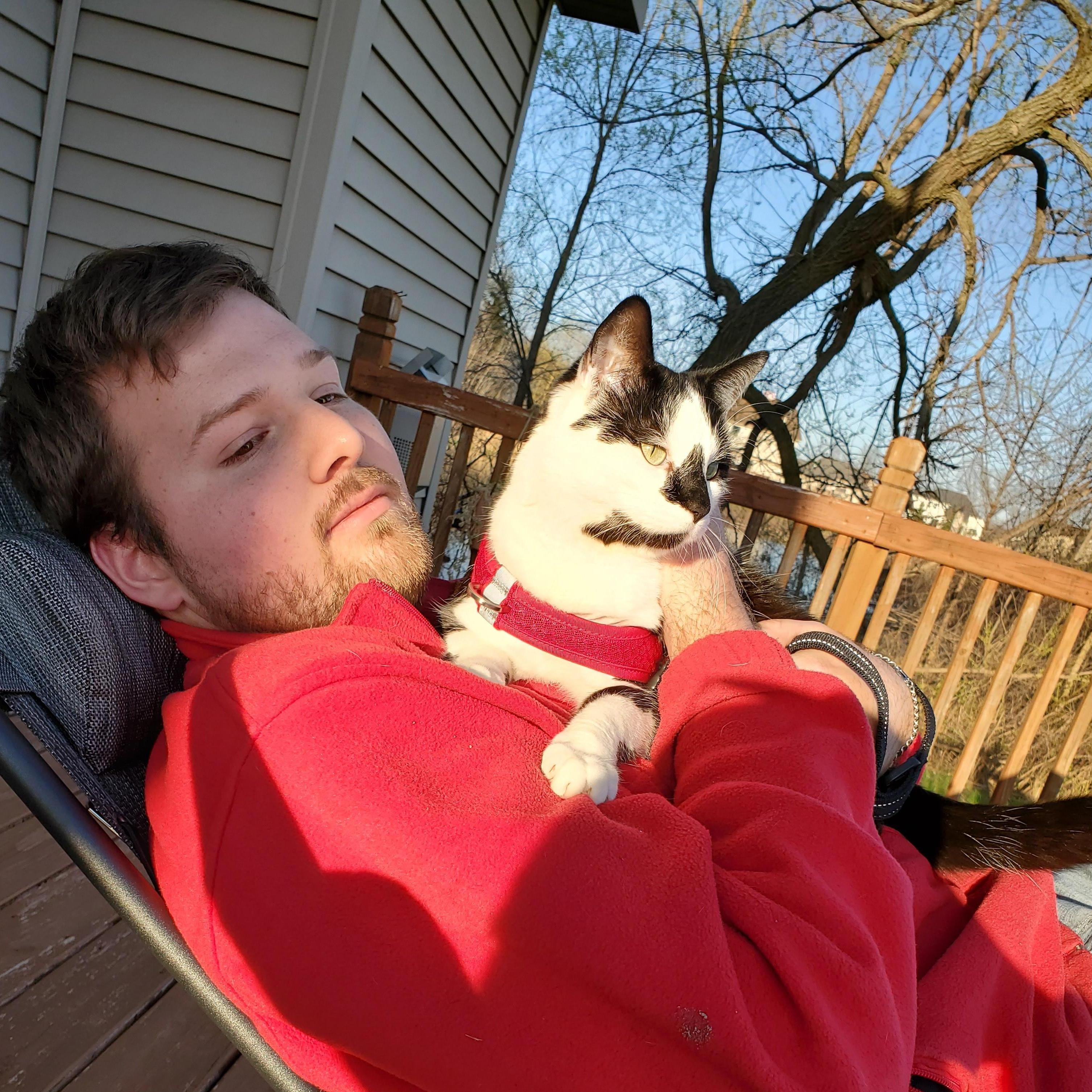 Just a man and his cat, enjoying the sun