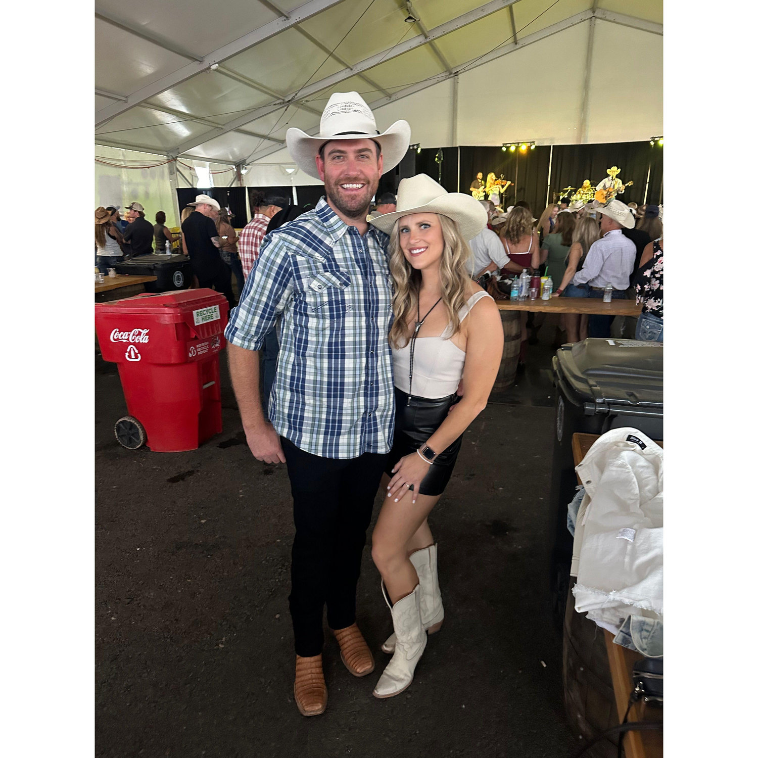 Kathleen turning Evan into a cowboy - Cheyenne Frontier Days - July 2024