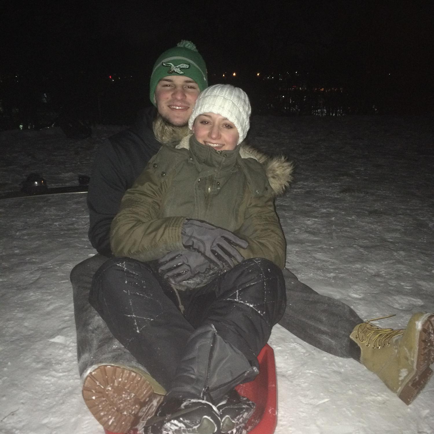 Sledding in 2017 on the hill where we got engaged in 2024!