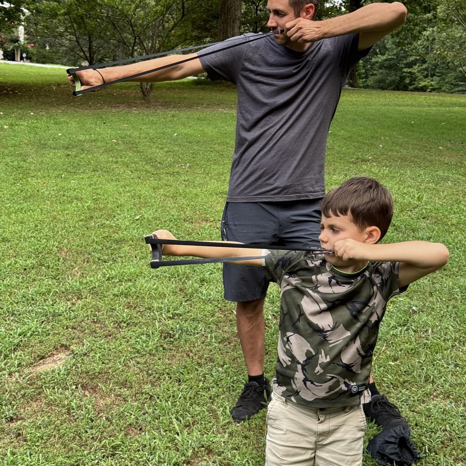 The boys practicing with their slingshots