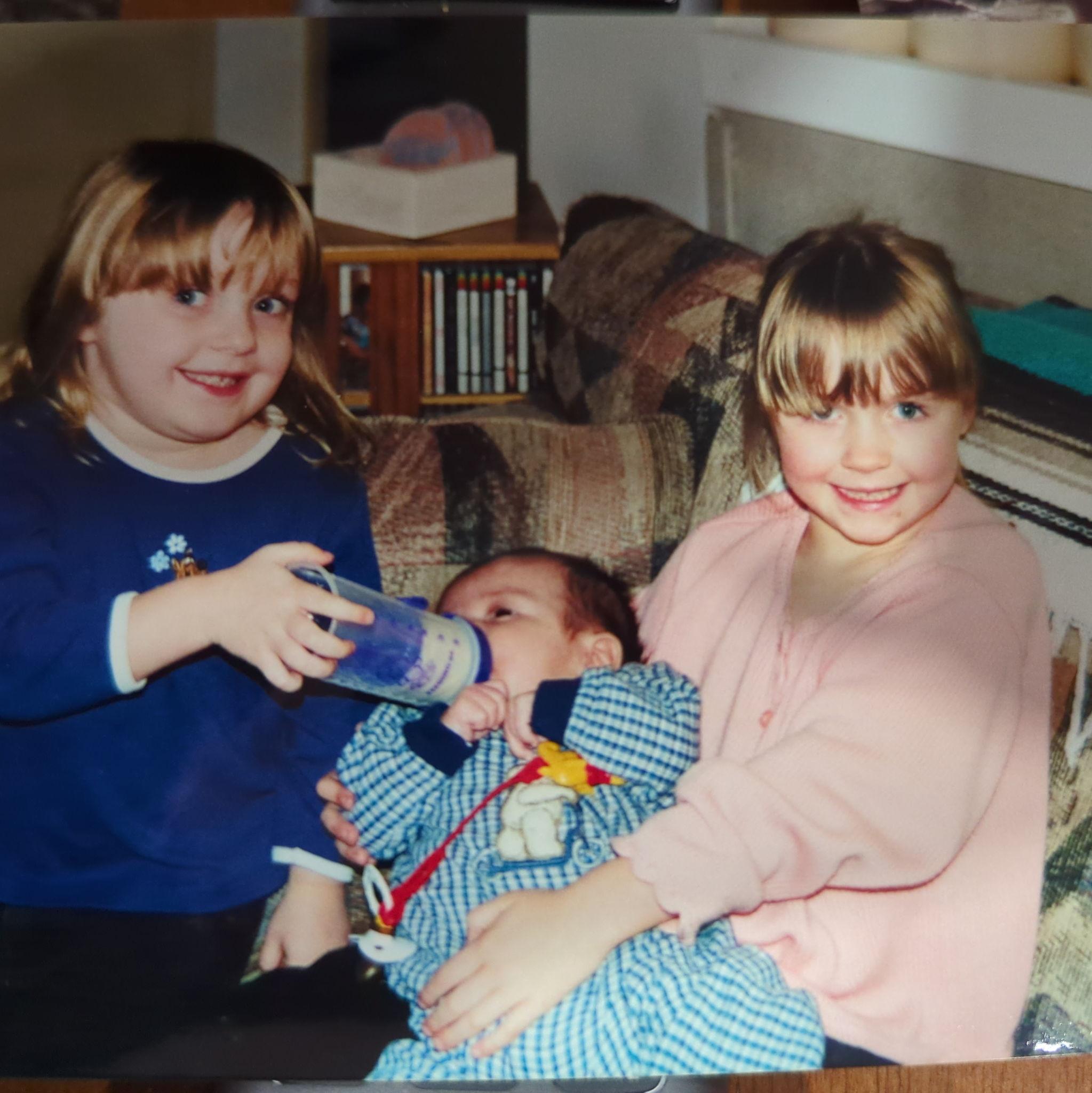 Tay and her family have been a part of the Smolko's life for decades. This is Tay and her sister feeding a baby Tyler!