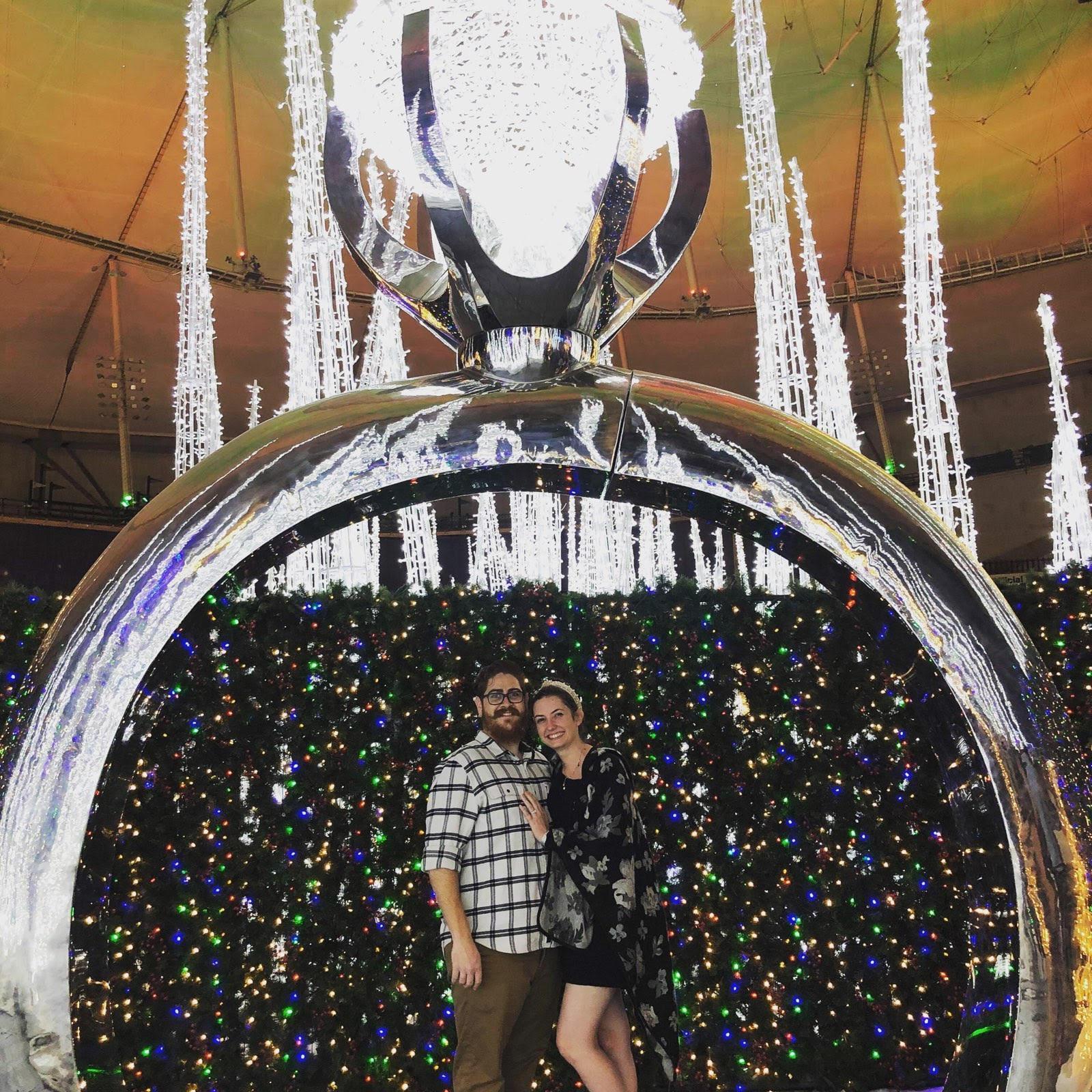 This picture was taken the day after we got engaged at the Enchant Christmas display at Tropicana field! It felt like the perfect time to take a picture underneath an engagement ring.