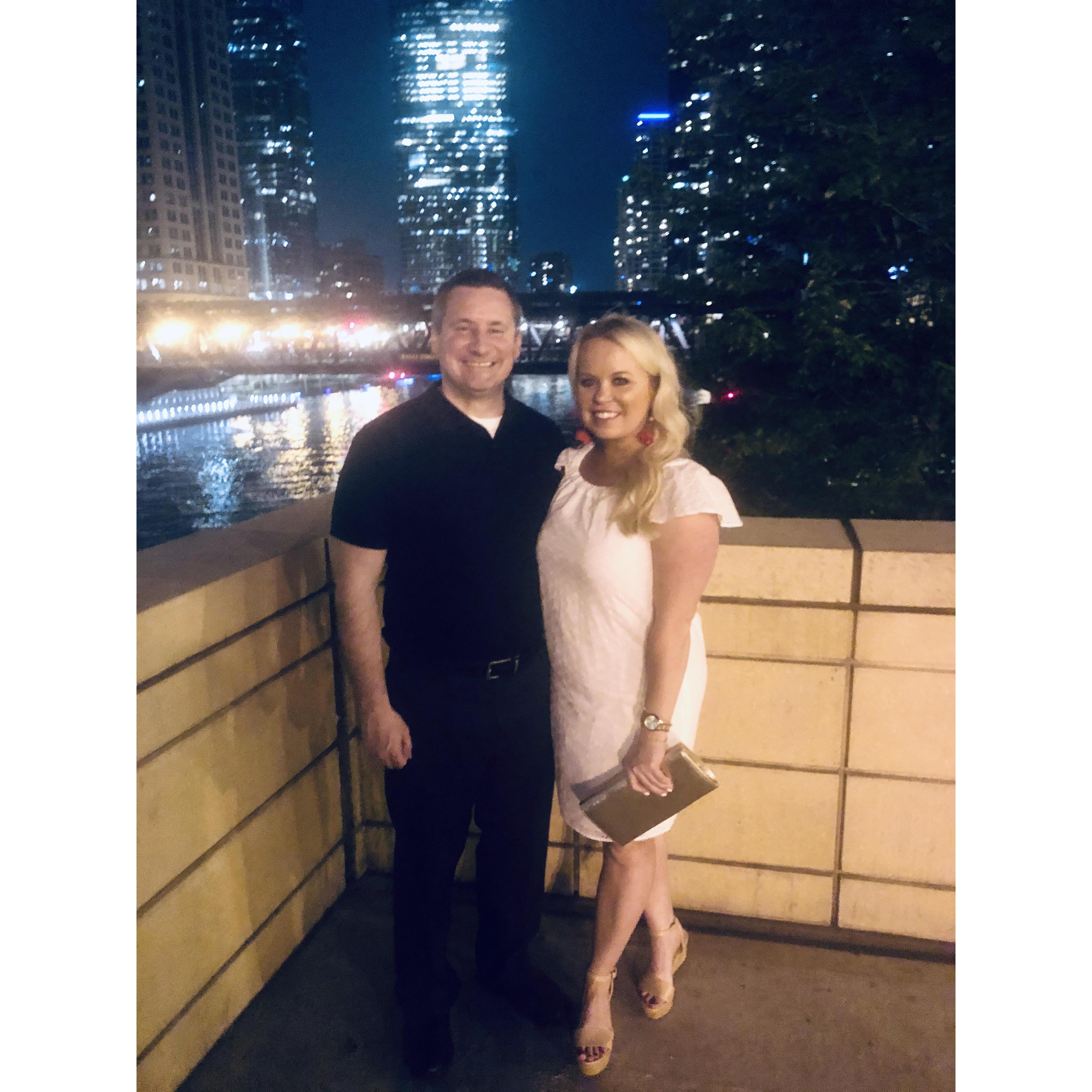 Celebrating our 2 year anniversary last June on the river in Chicago. We are holding our masks.