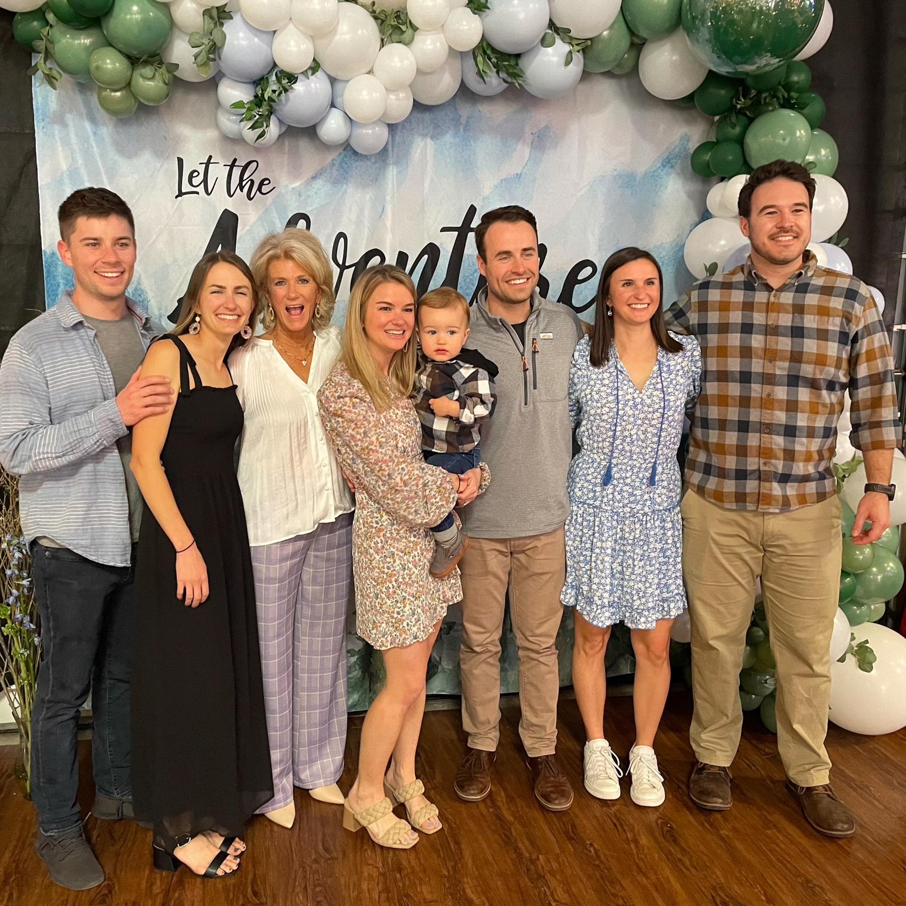 Brian sneaks into a family photo early on