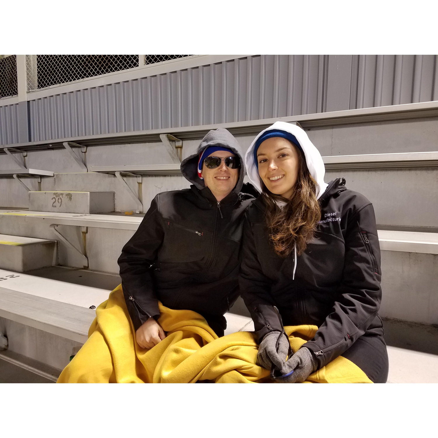 Staying close for warmth at a Georgia Tech football game.