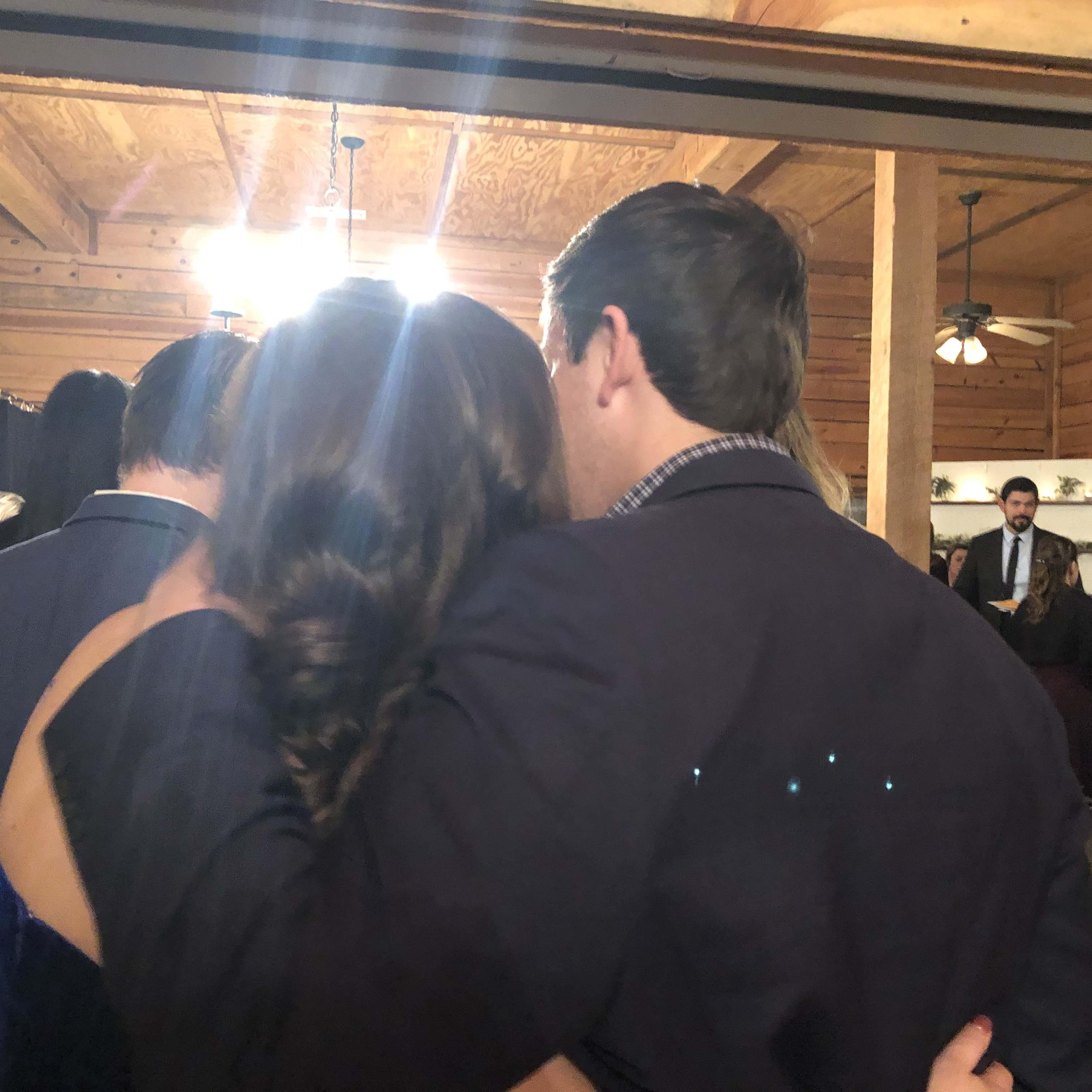 A wedding, not sure which one, being lovey dovey