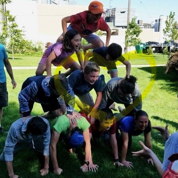 Next to each other on our annual human pyramid during our camping trip to Ludington, Michigan.