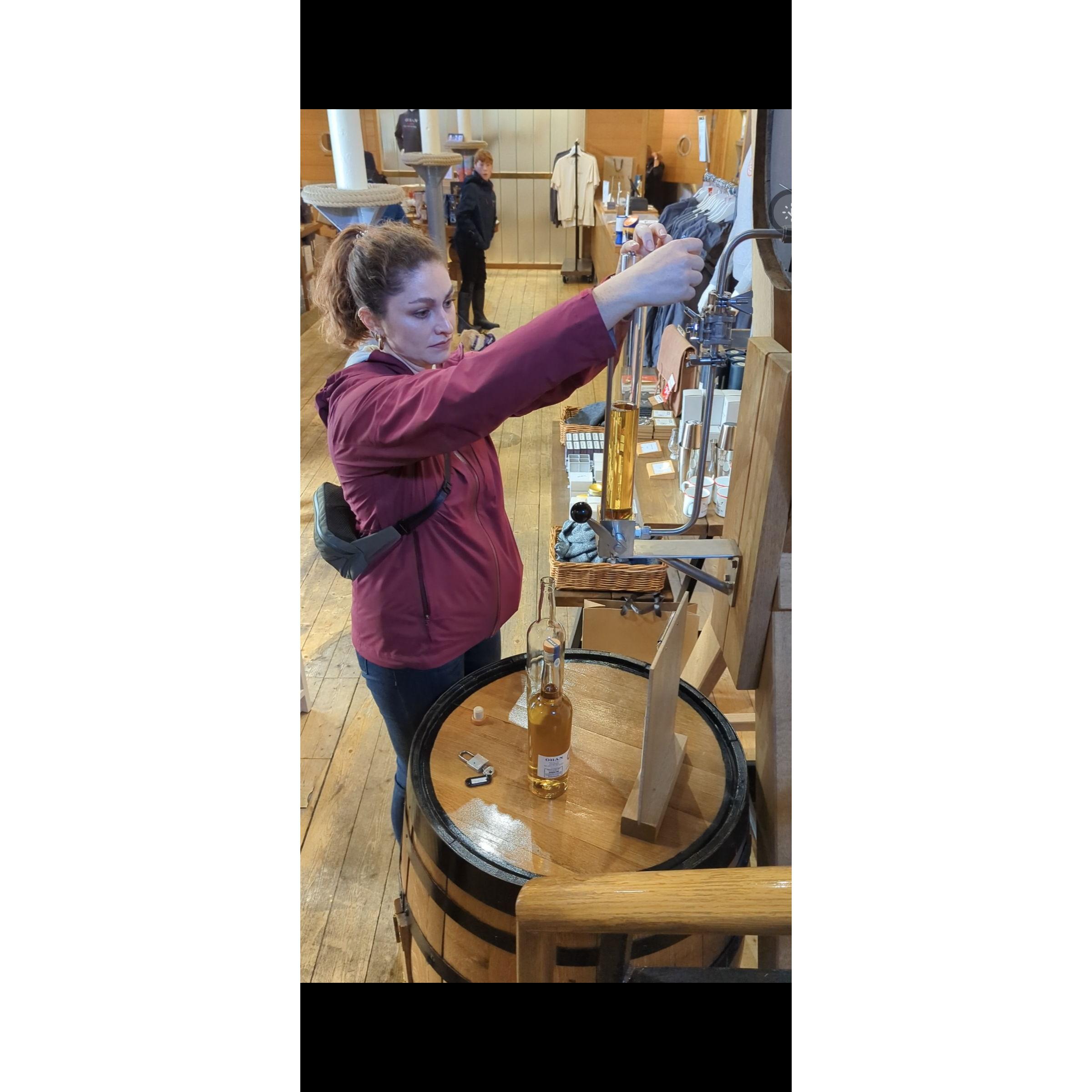 Zoe filling a special bottle of Scotch at Oban