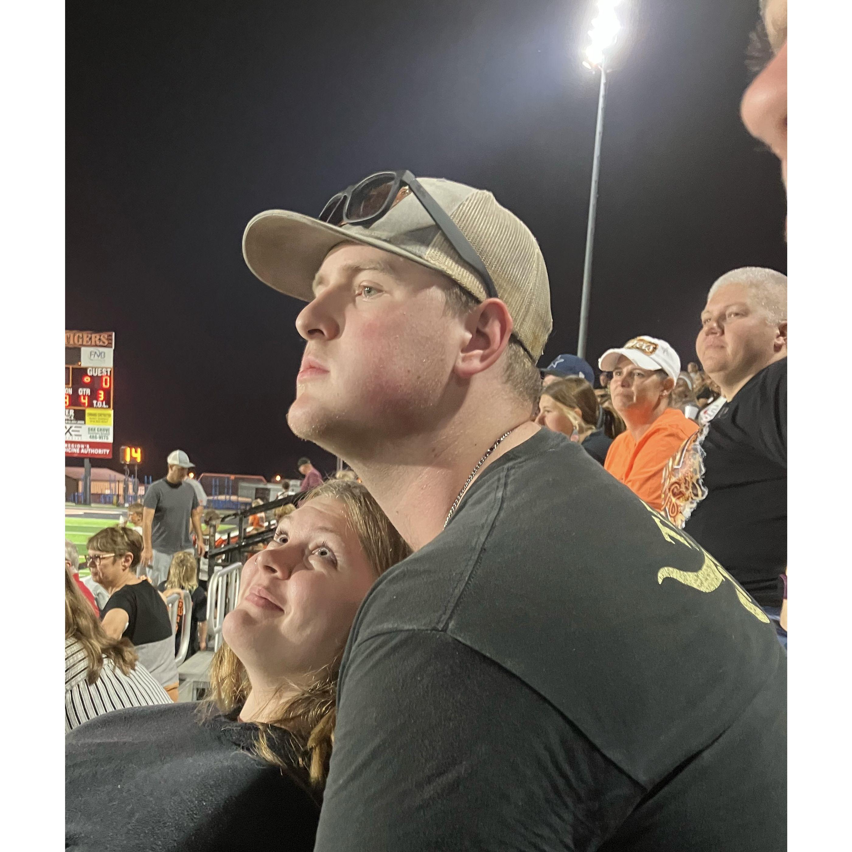 Watching our first high school football game together