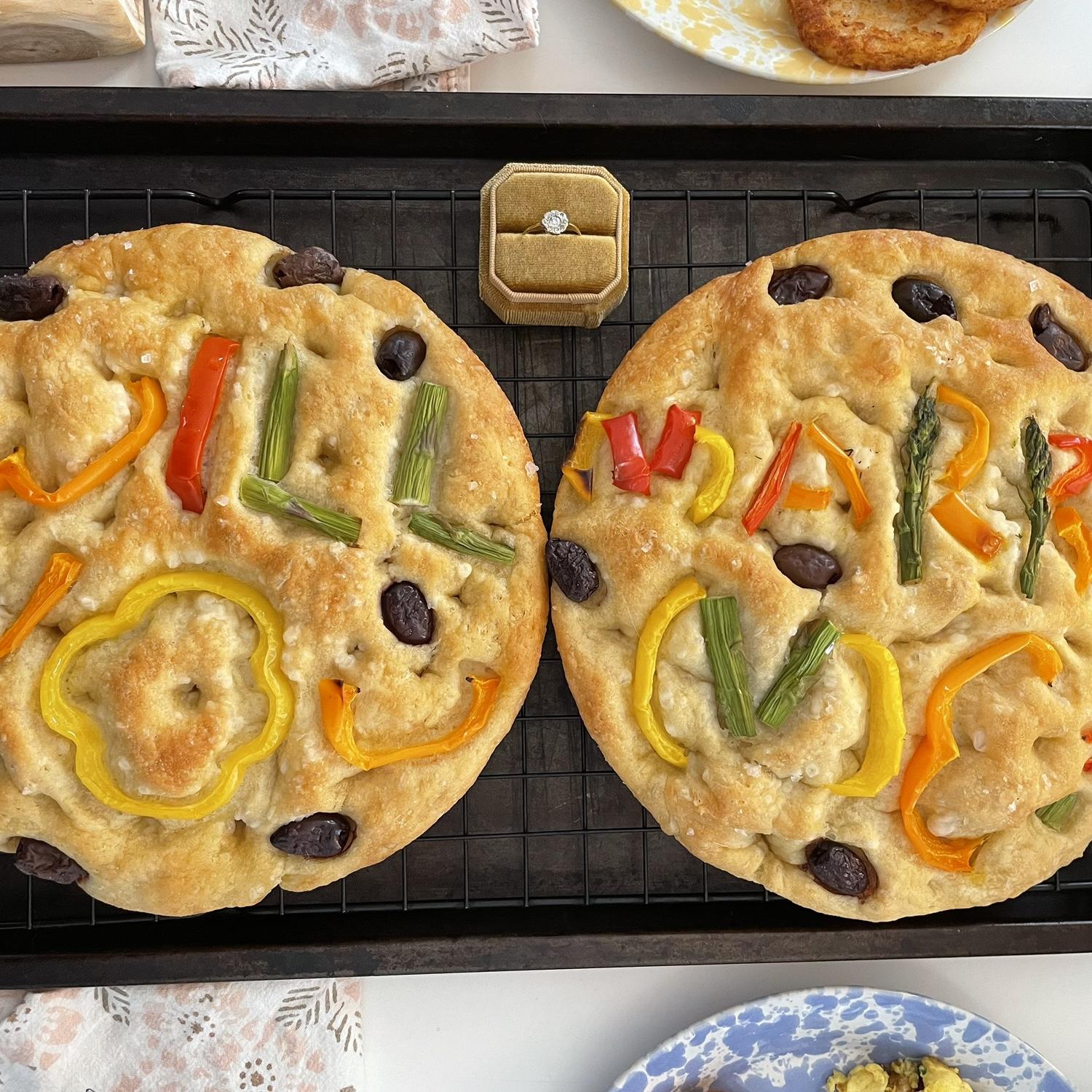 Ella’s homemade focaccia that says “Will you marry me?” with veggies