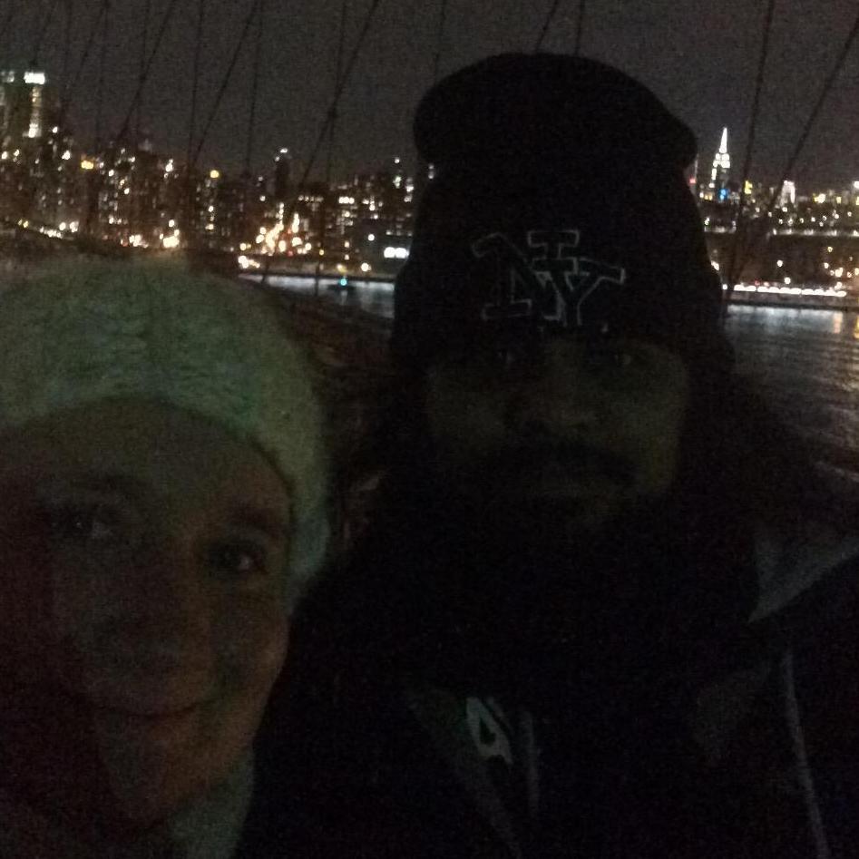 Walking the Brooklyn Bridge at night in New York.
